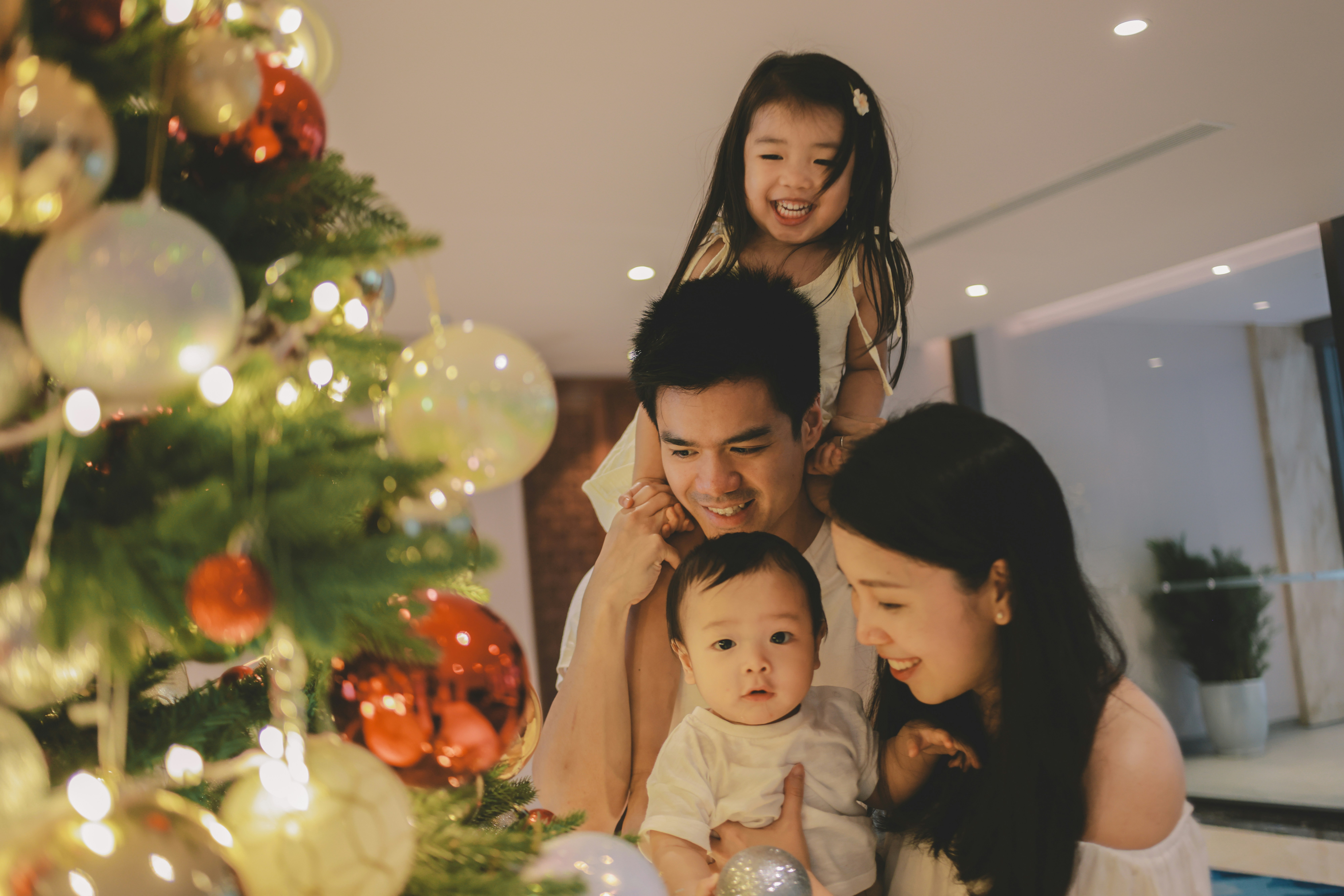 Family decorating a christmas tree together