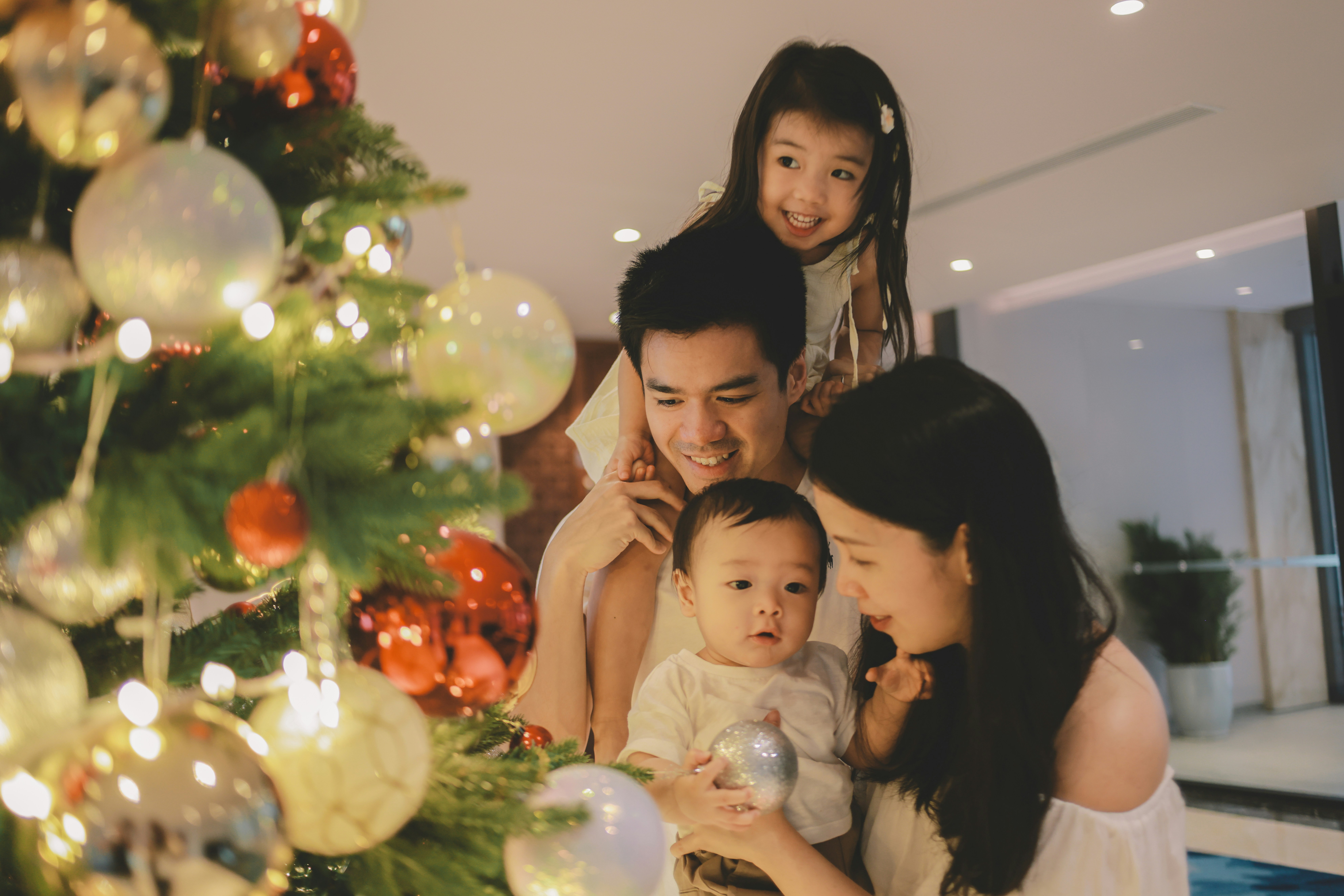 Family admiring a decorated christmas tree