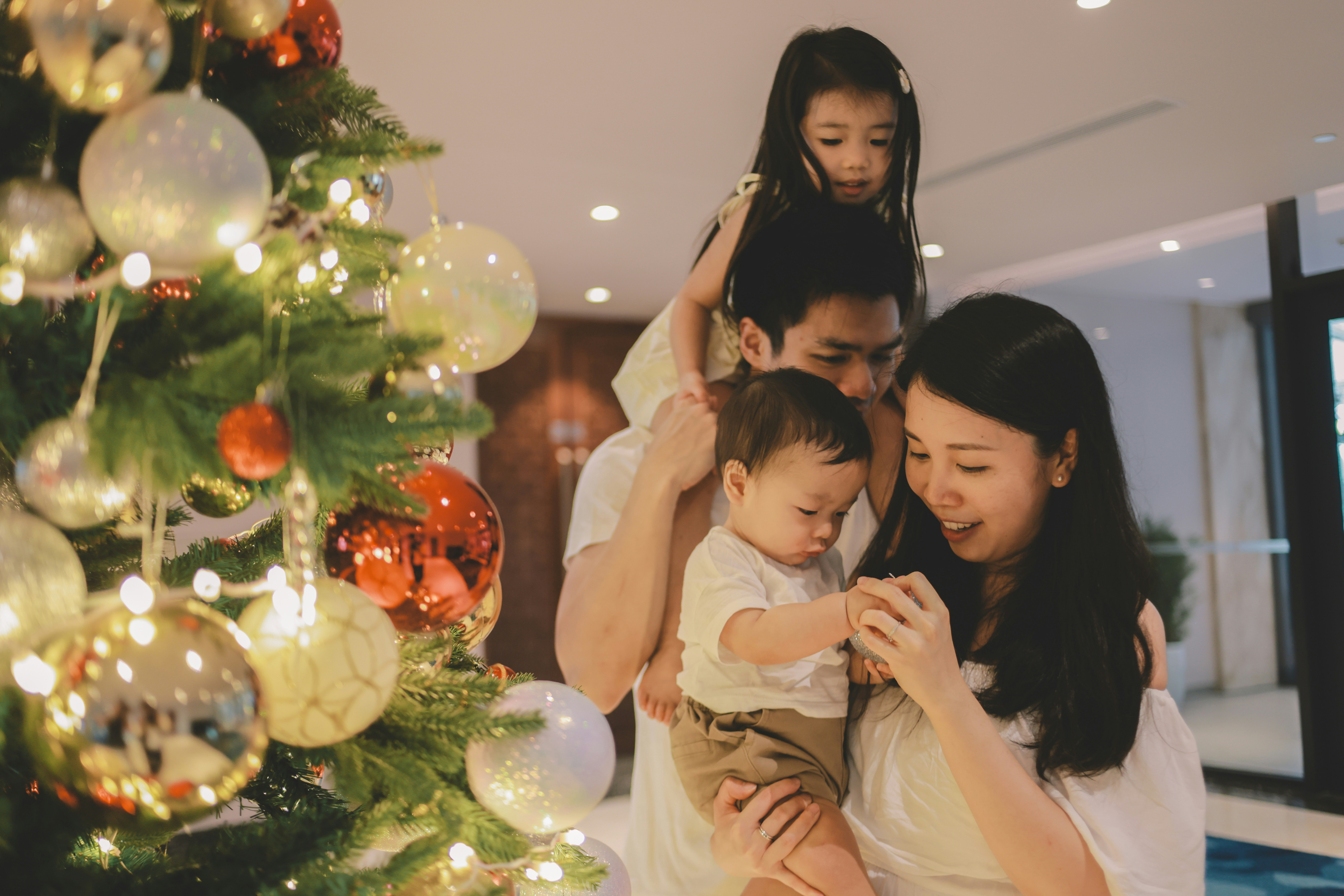 Family celebrating christmas near a decorated tree.