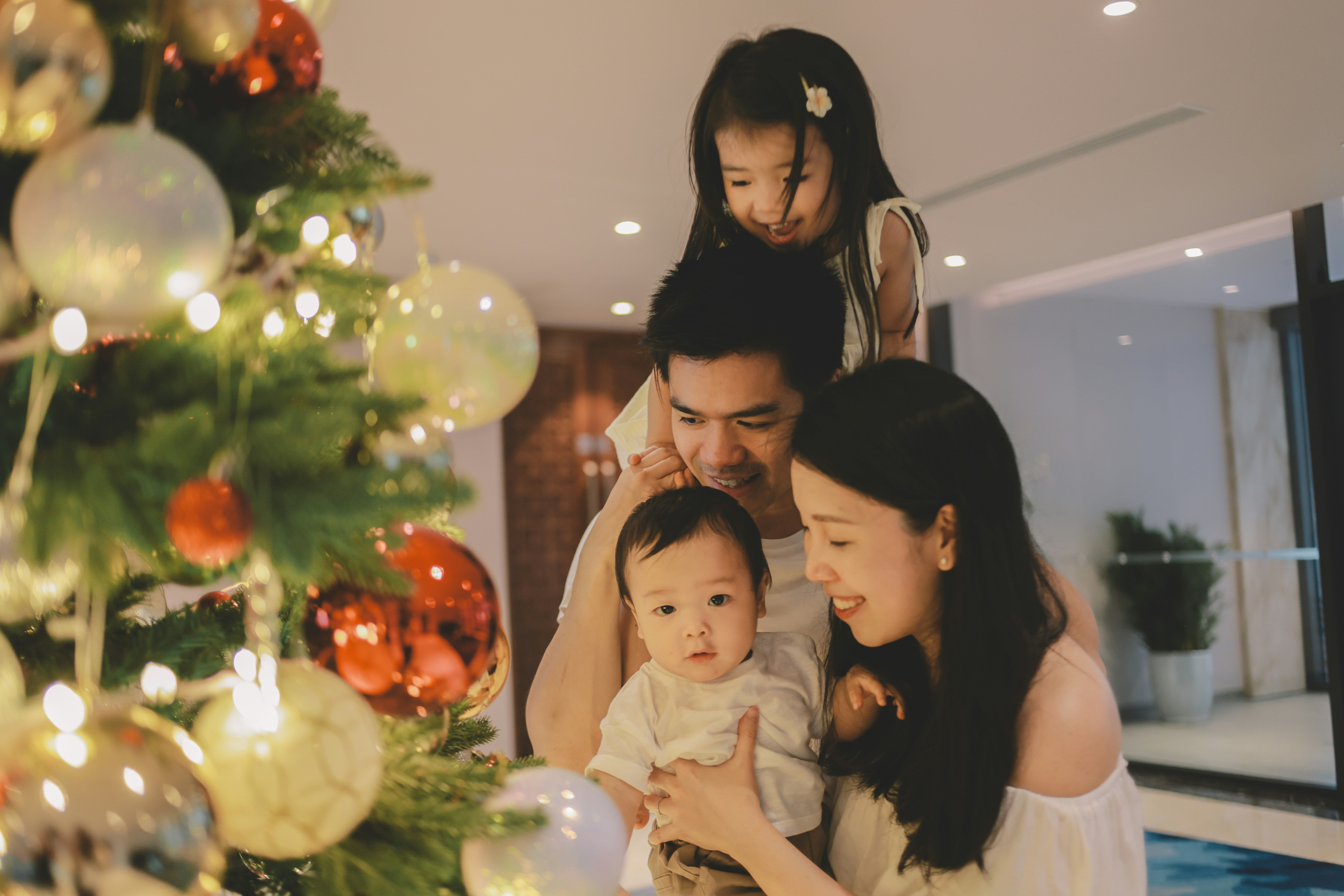 Family decorating a christmas tree together