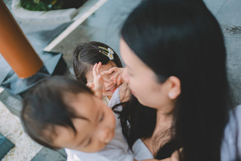 Parent gently holding a newborn's tiny foot