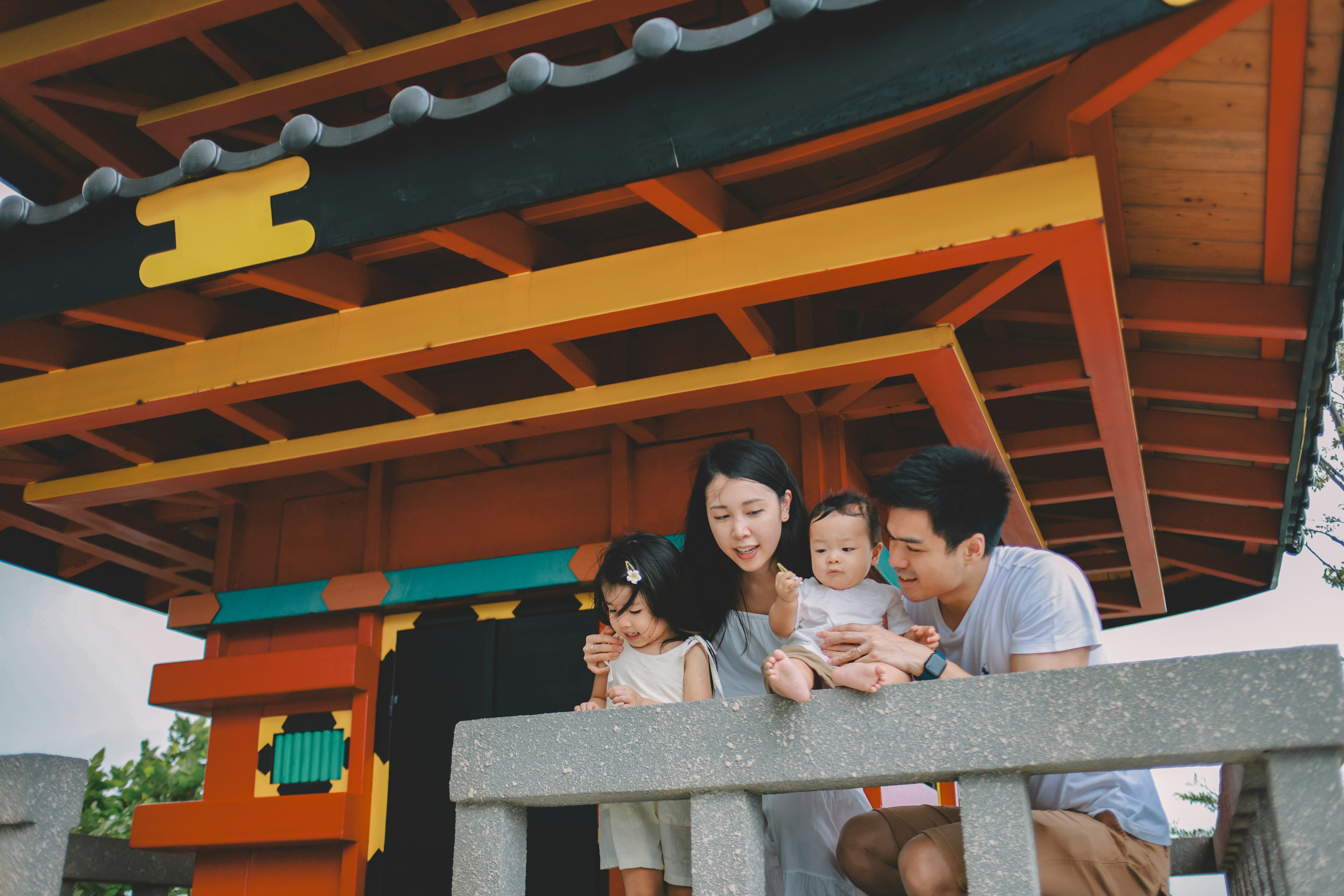 Family looking at a colorful japanese structure