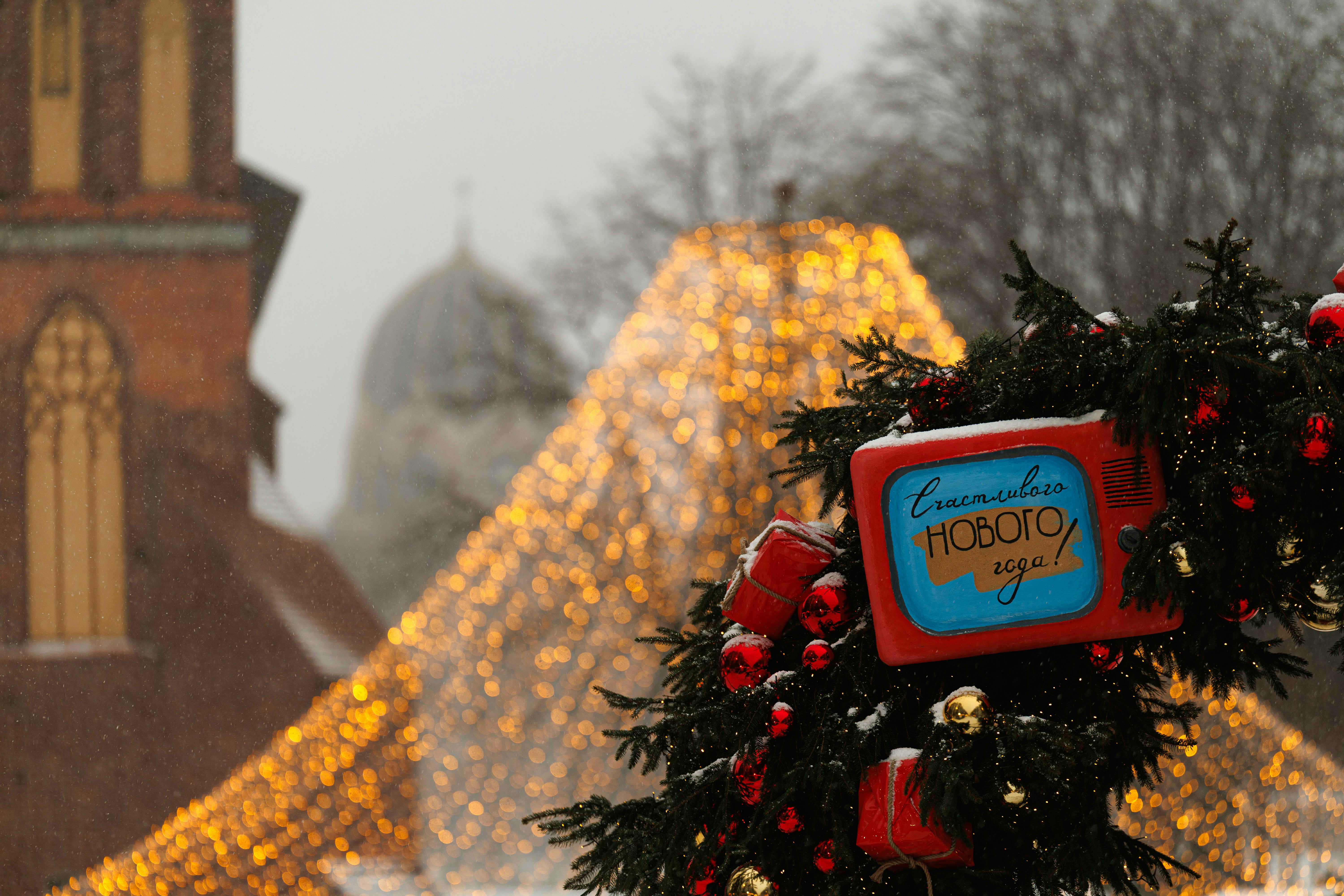 Christmas tree with vintage TV decoration and festive lights