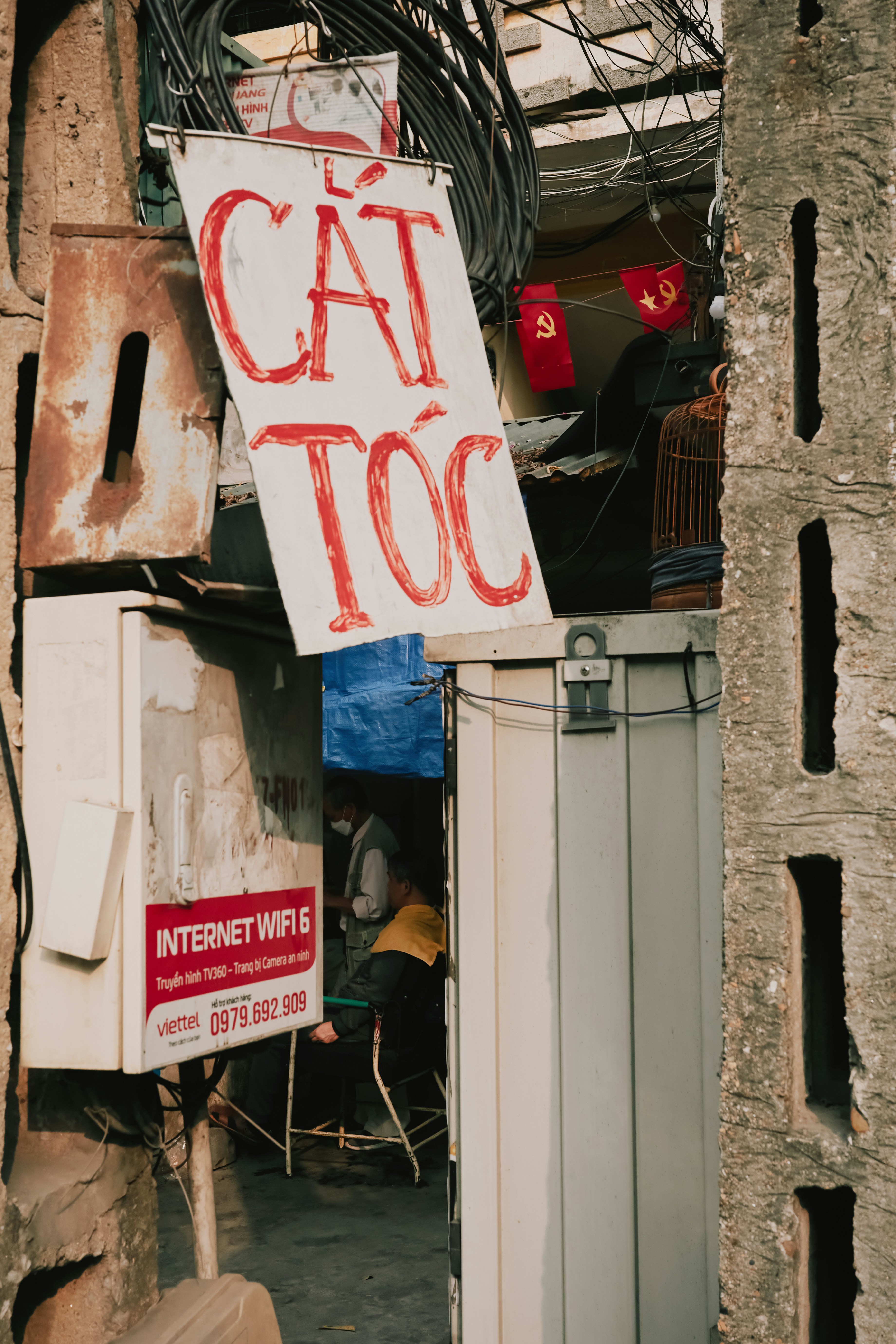 Traditional Barbershop Sign in a Narrow Vietnamese Alley