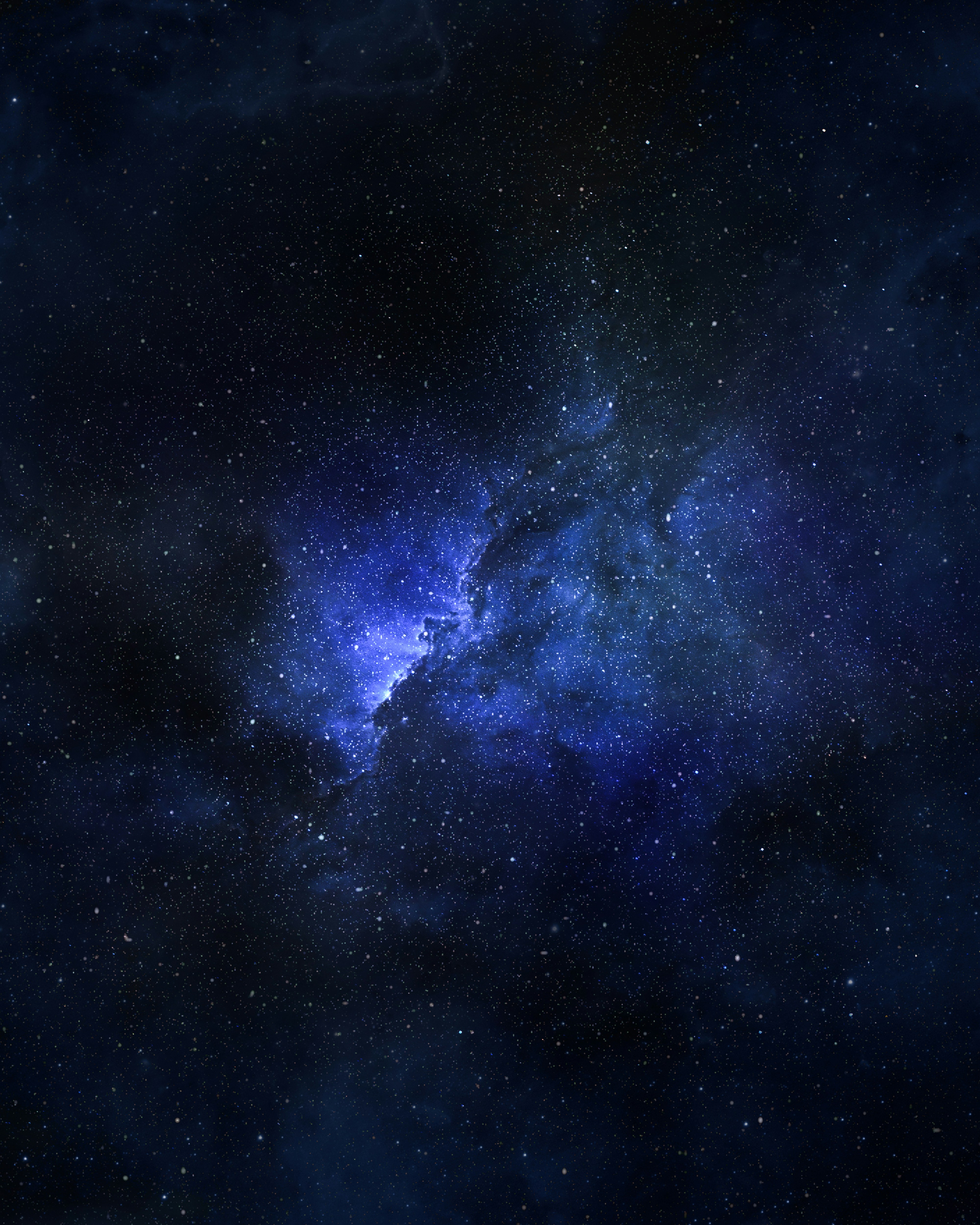 A vibrant blue nebula in a starry night sky