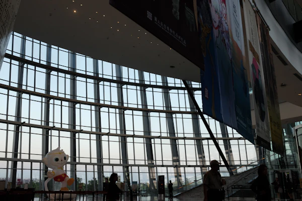Modern convention center interior with glass windows and banners