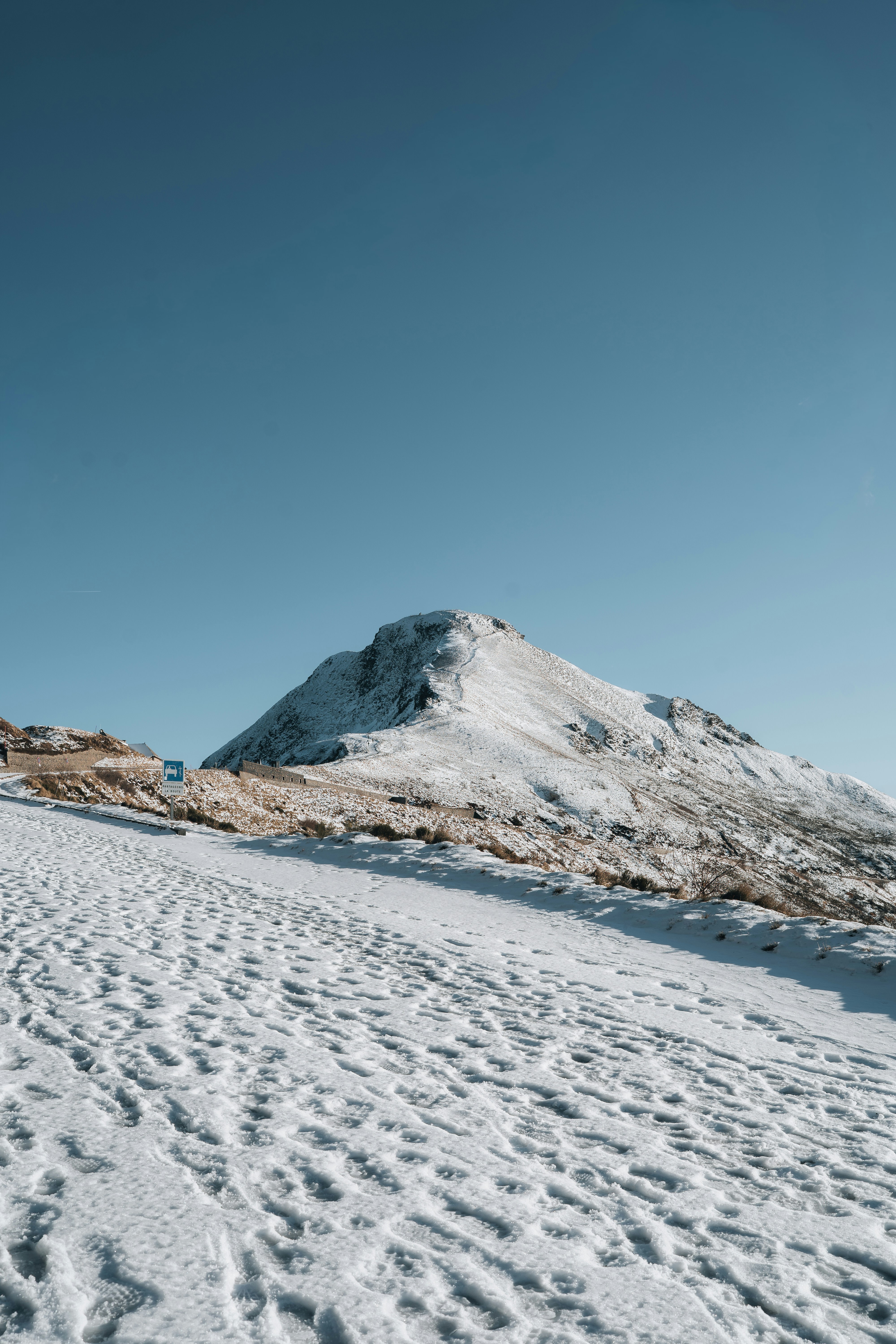 Snow-covered mountain peak under a clear blue sky