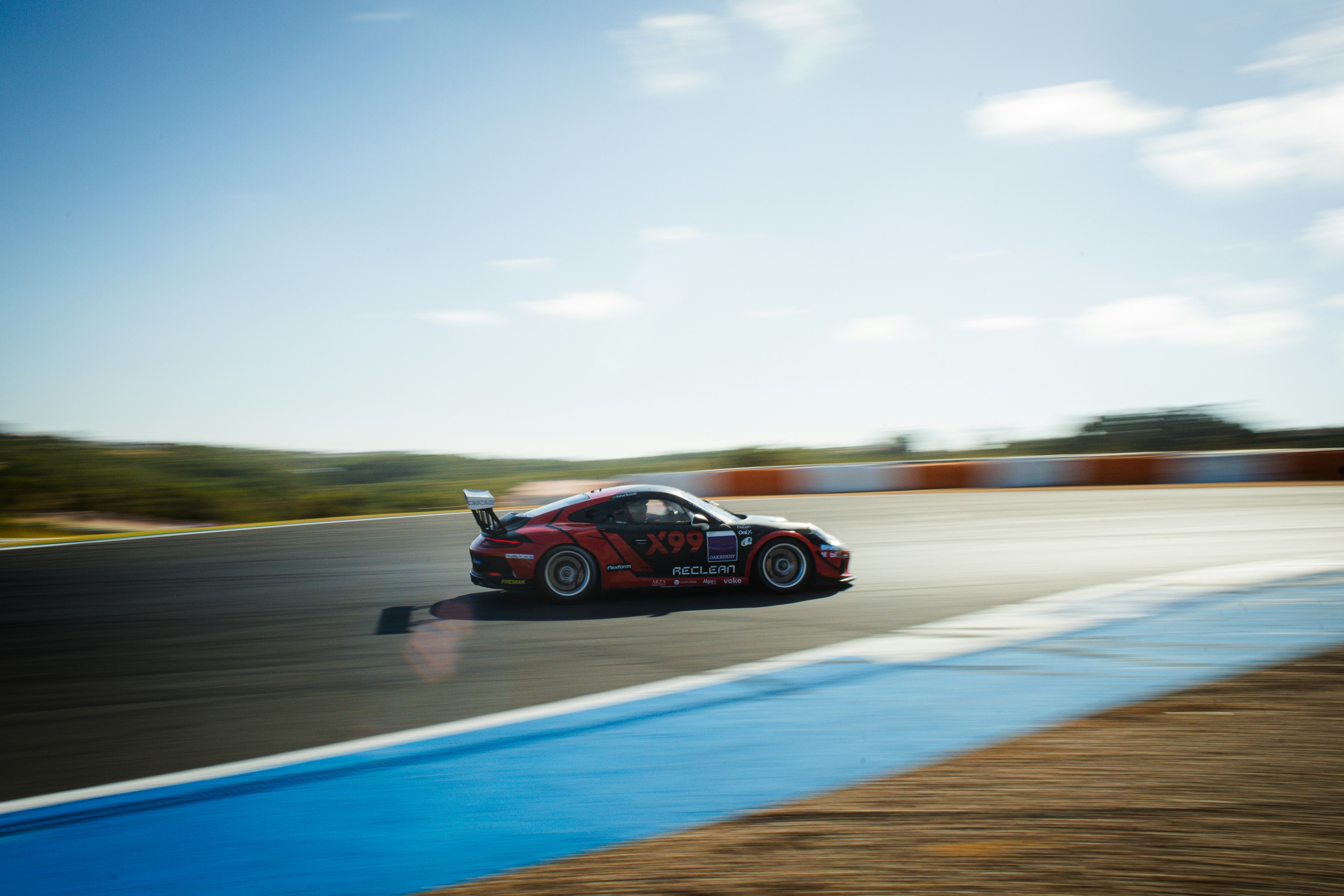 Red race car speeding around a track