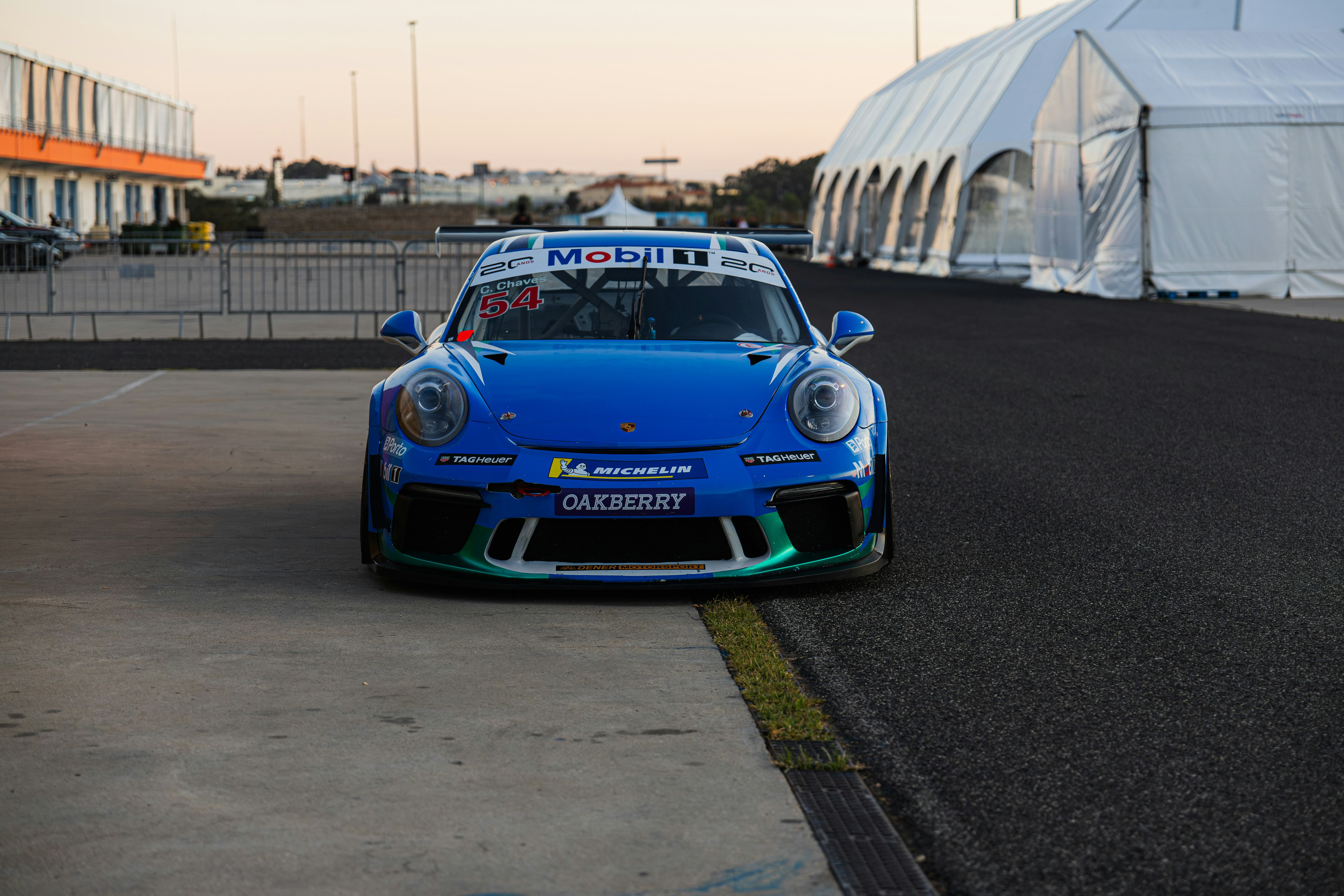 Blue racing car parked on asphalt track