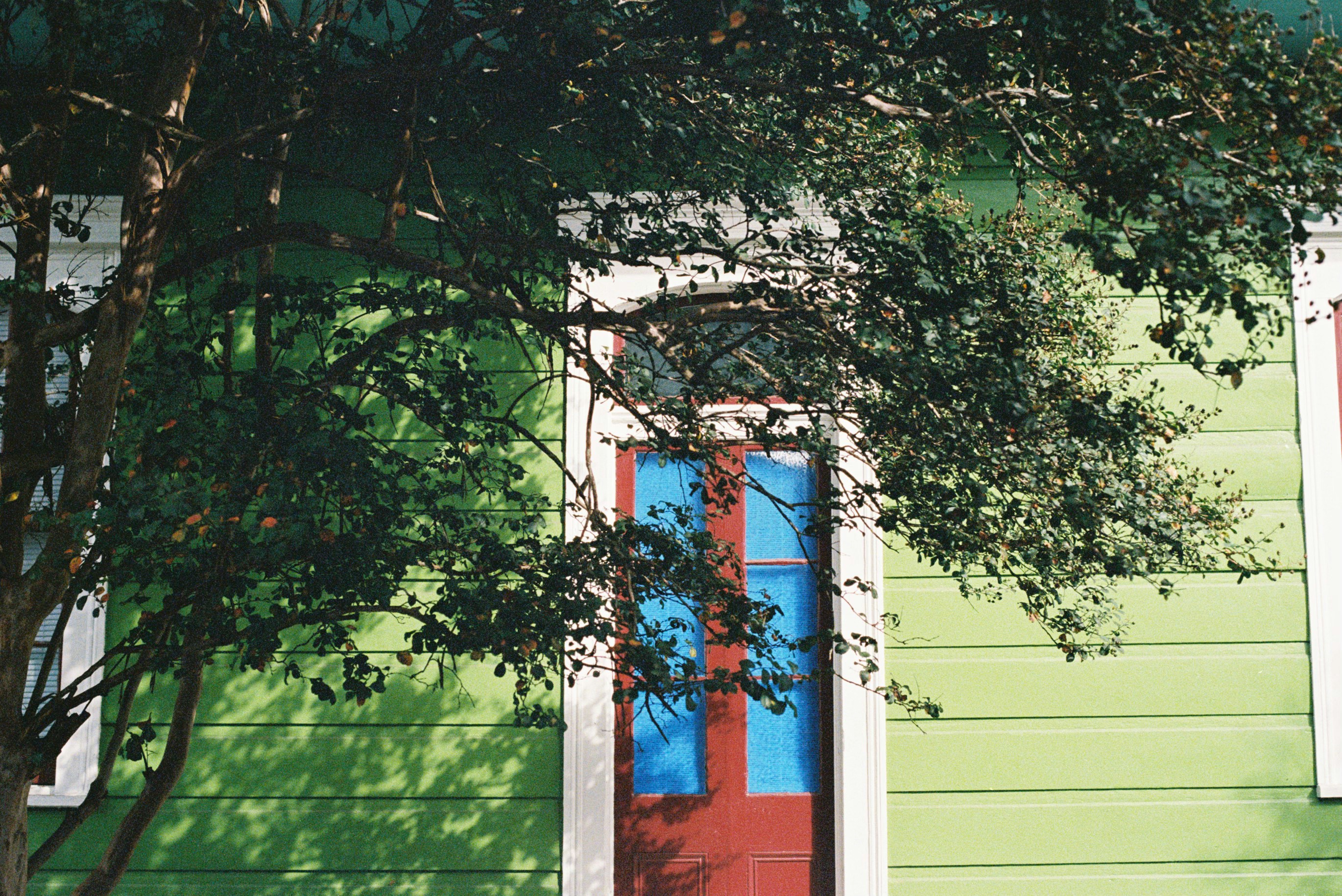 Old Windows With Faded Colors And Peeling Paint On A House Exterior