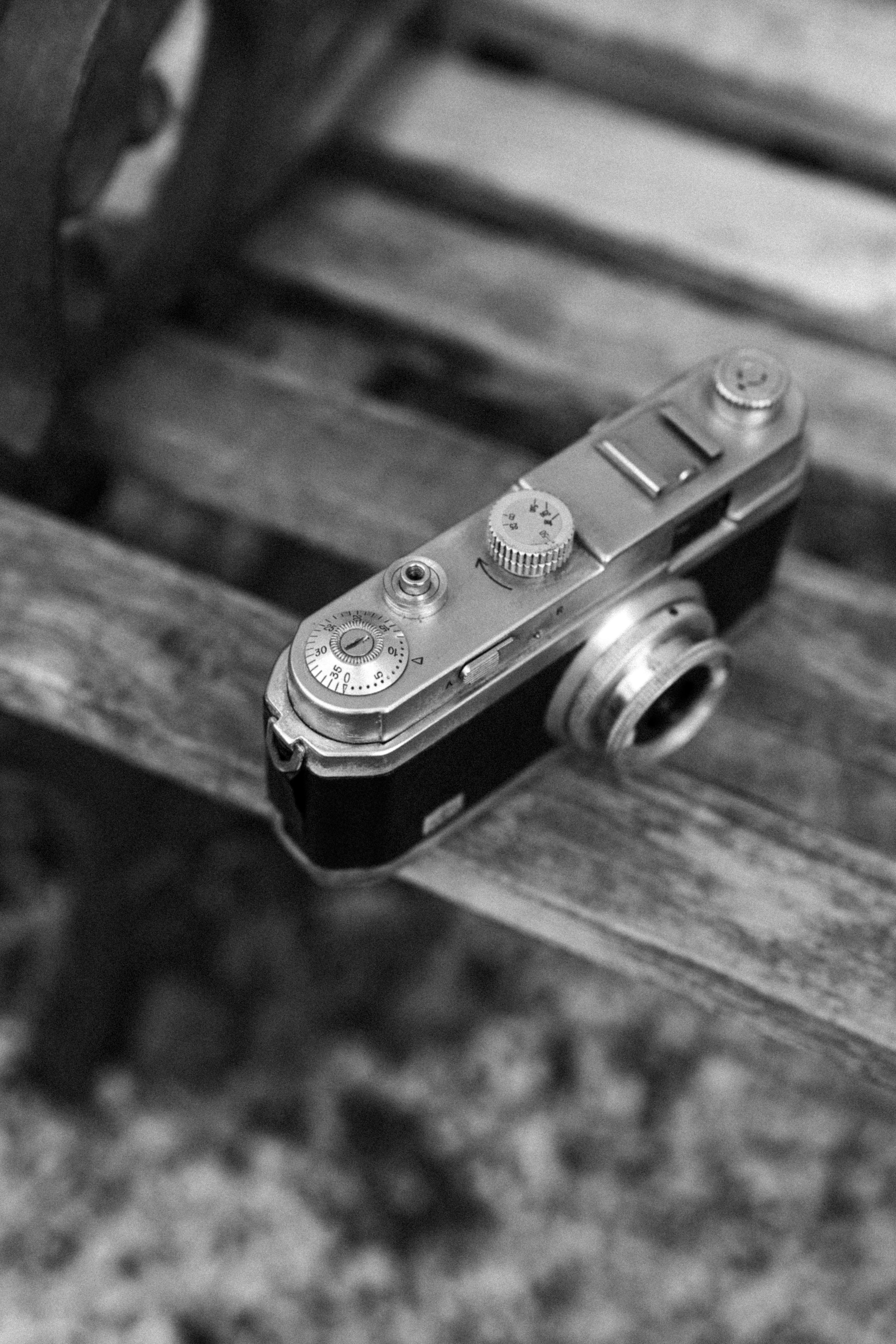Vintage camera resting on a wooden bench