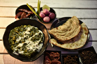 A delicious indian meal with spinach and flatbread