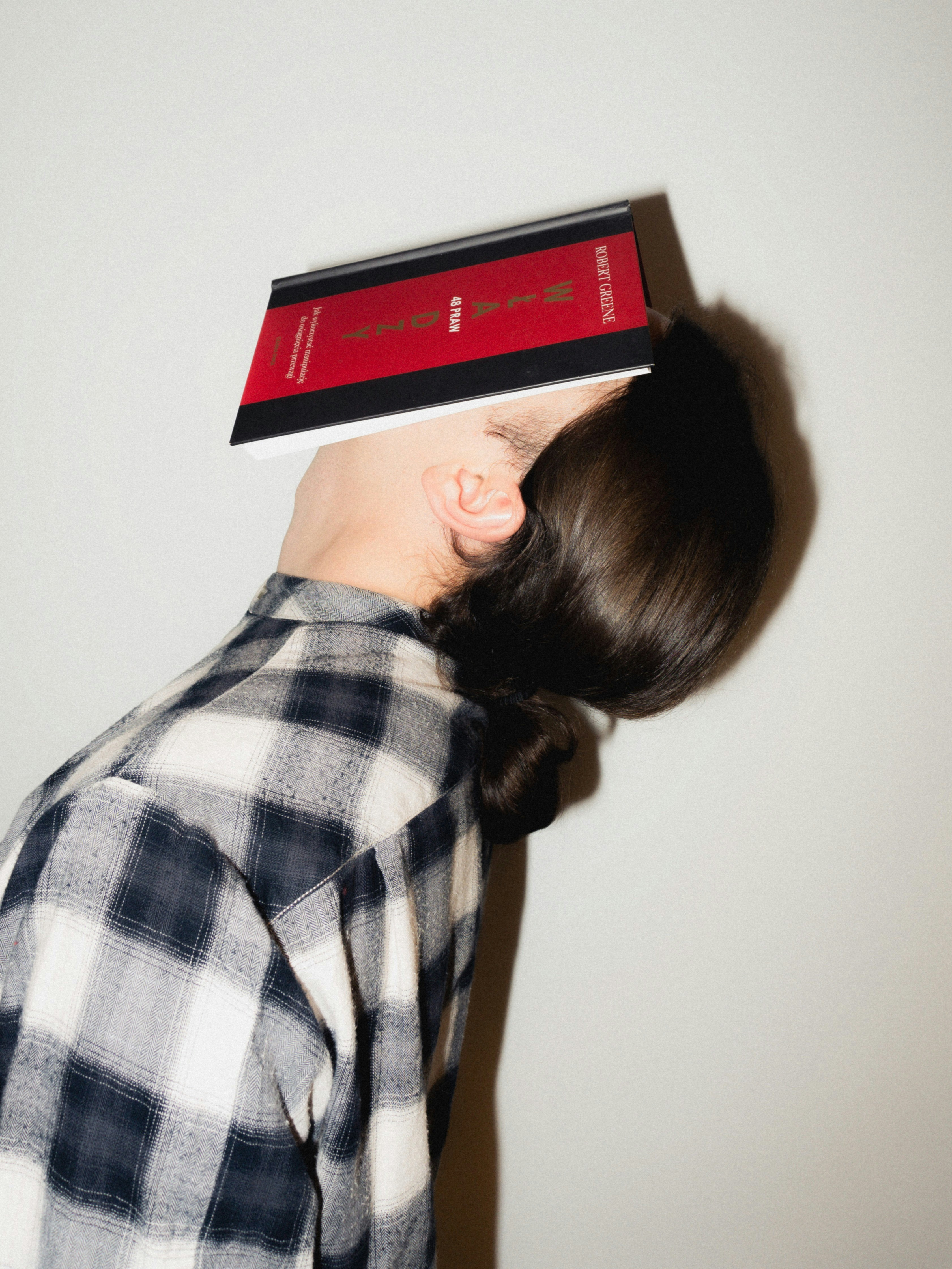 Person with book balanced on head