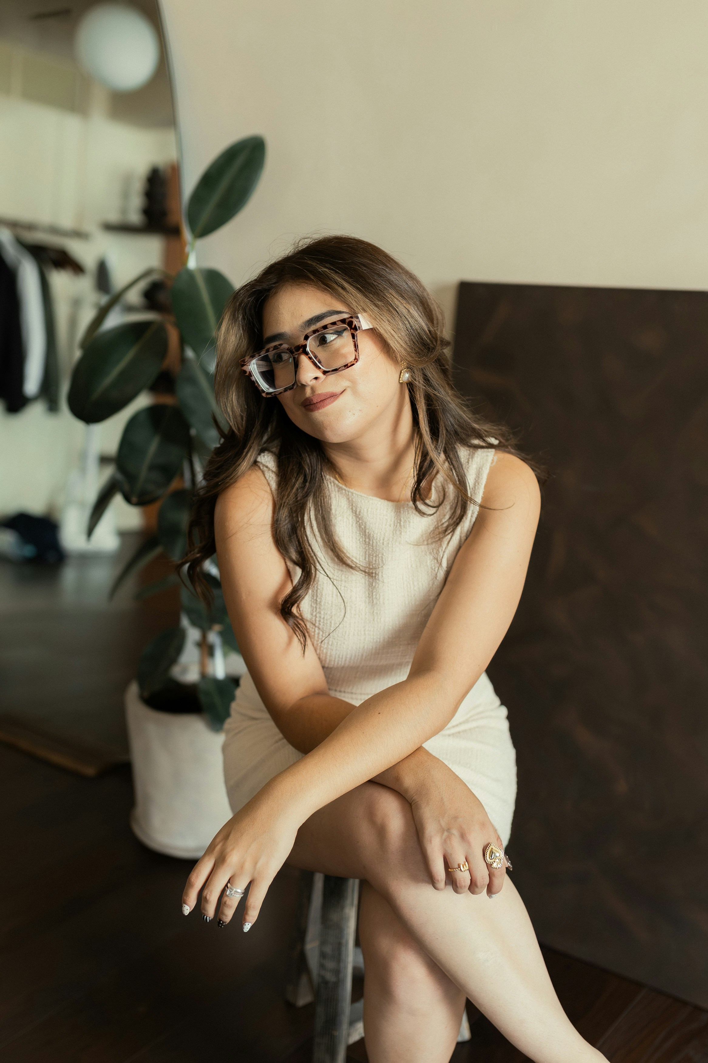 眼鏡をかけた女性がスタジオに座っている