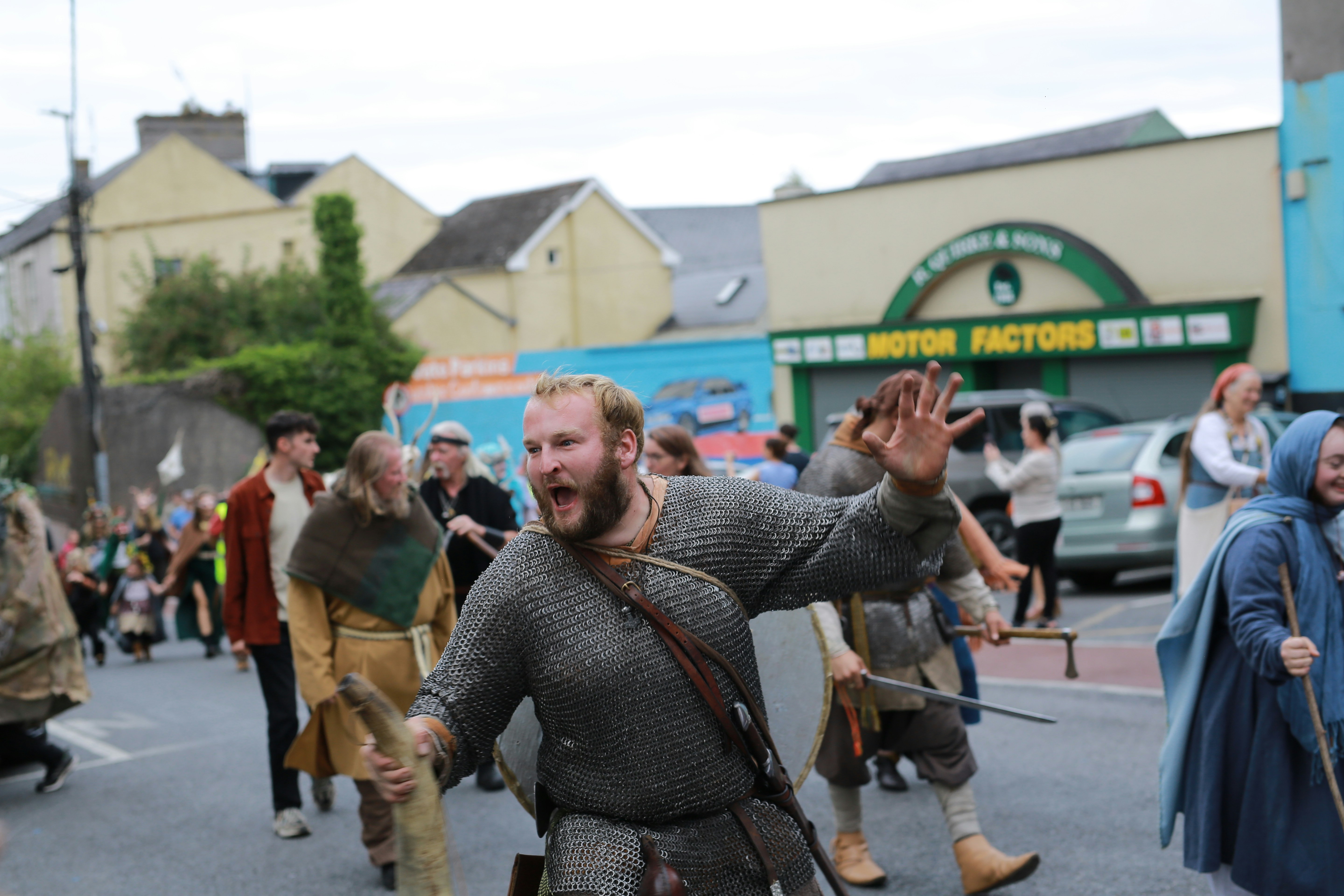 Man in medieval costume leading a parade