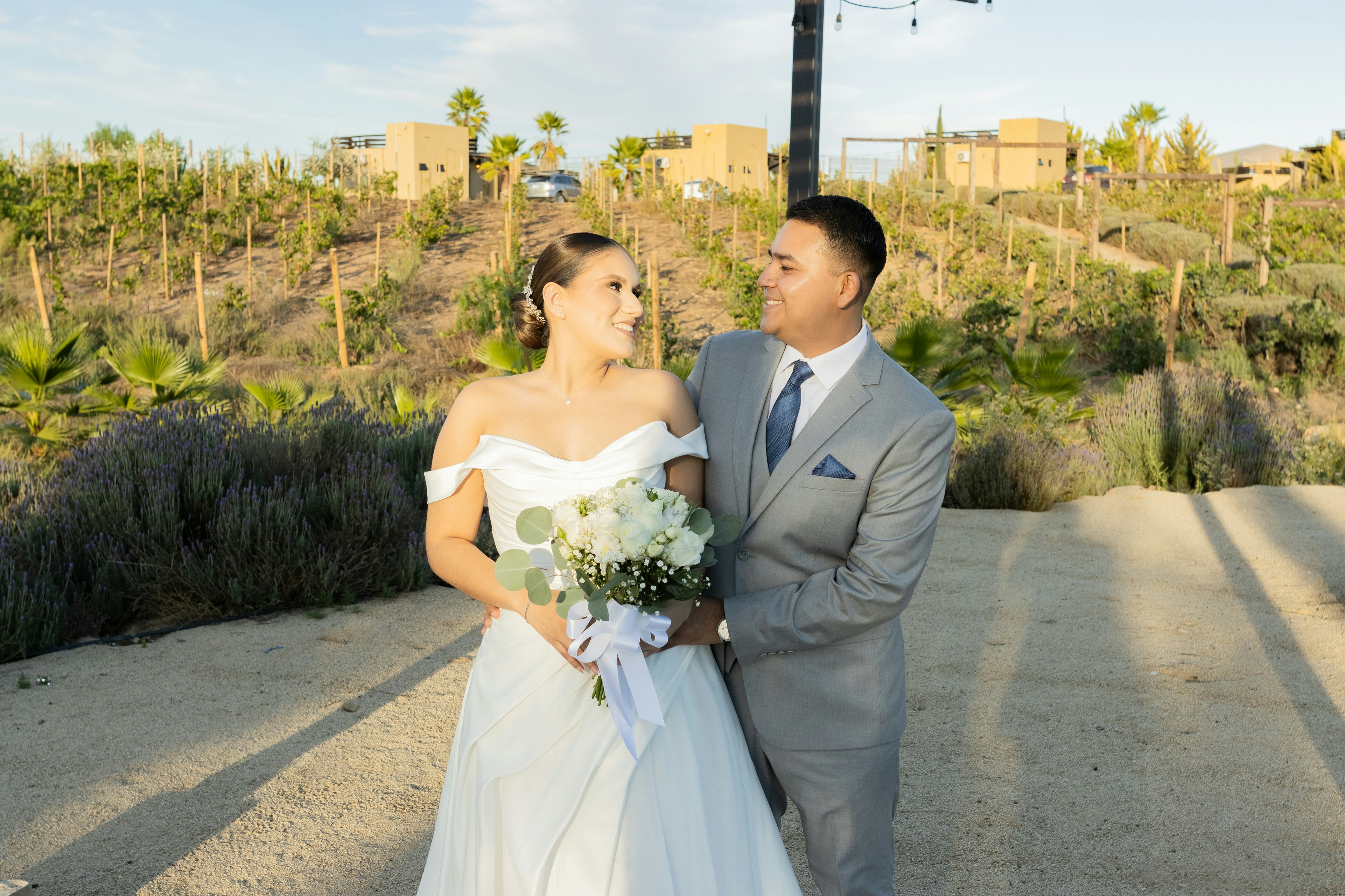Bride and groom looking at each other outdoors