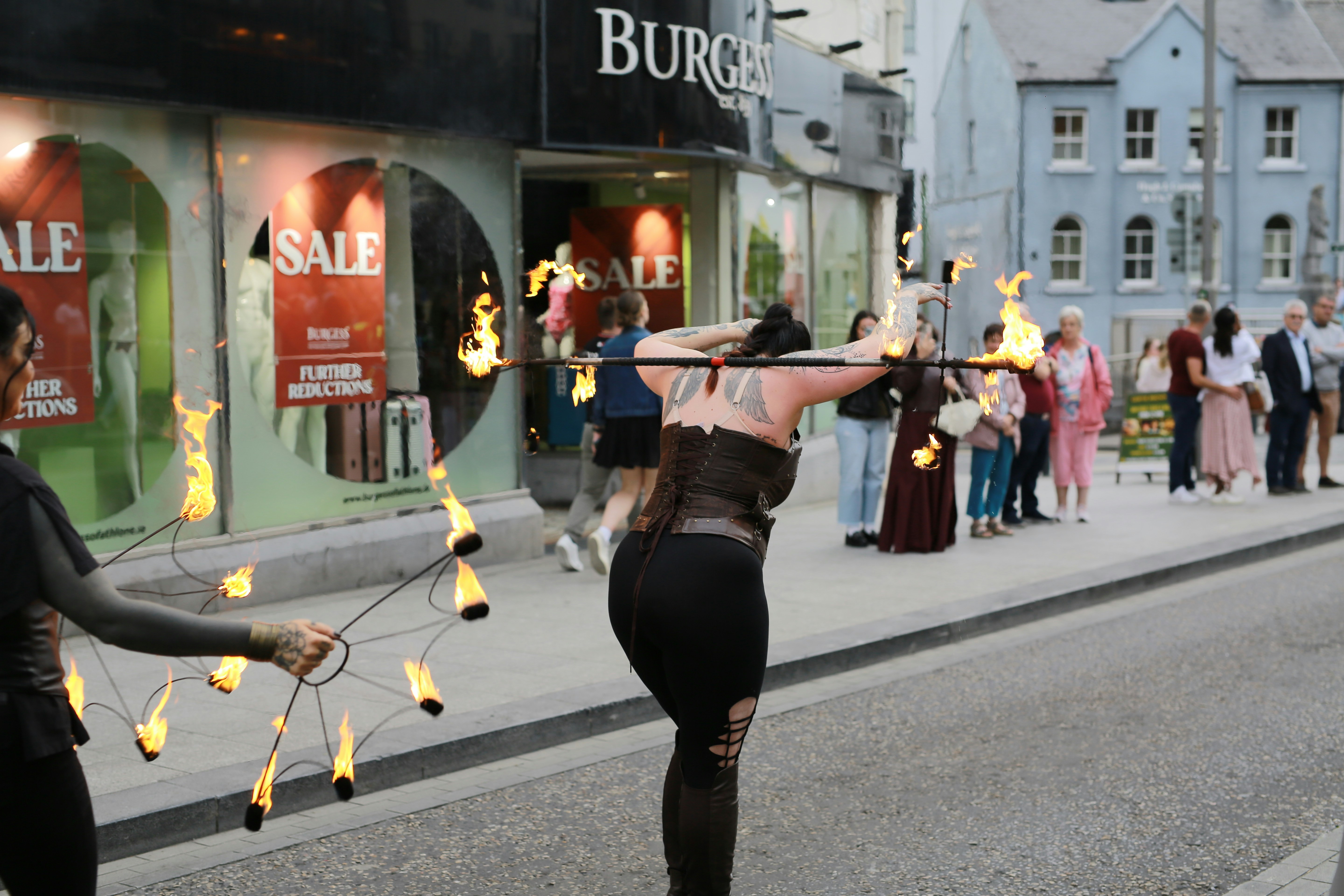 Performers doing fire dancing on a street