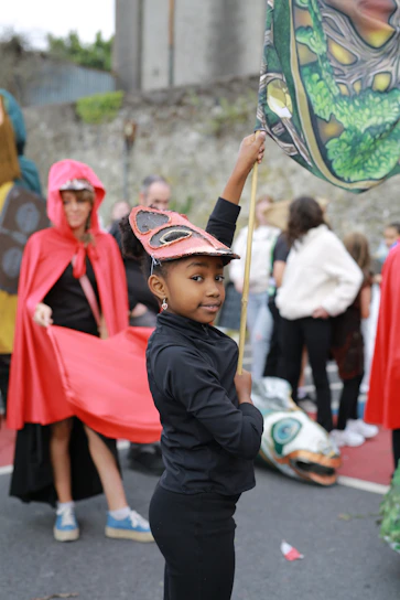 Young girl in a mask at a parade