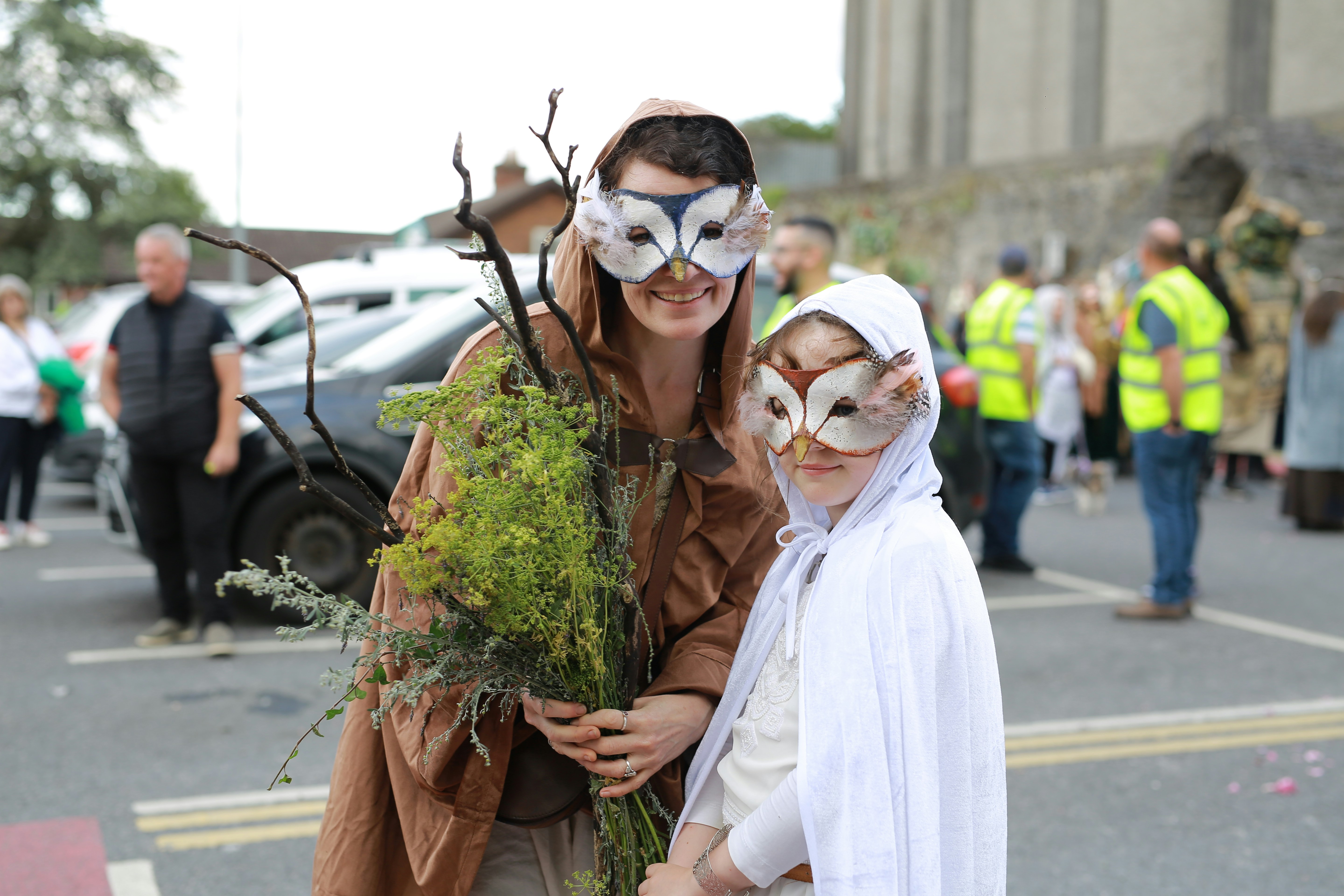 Two people in owl masks and costumes