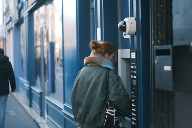 Woman using an atm on a city street