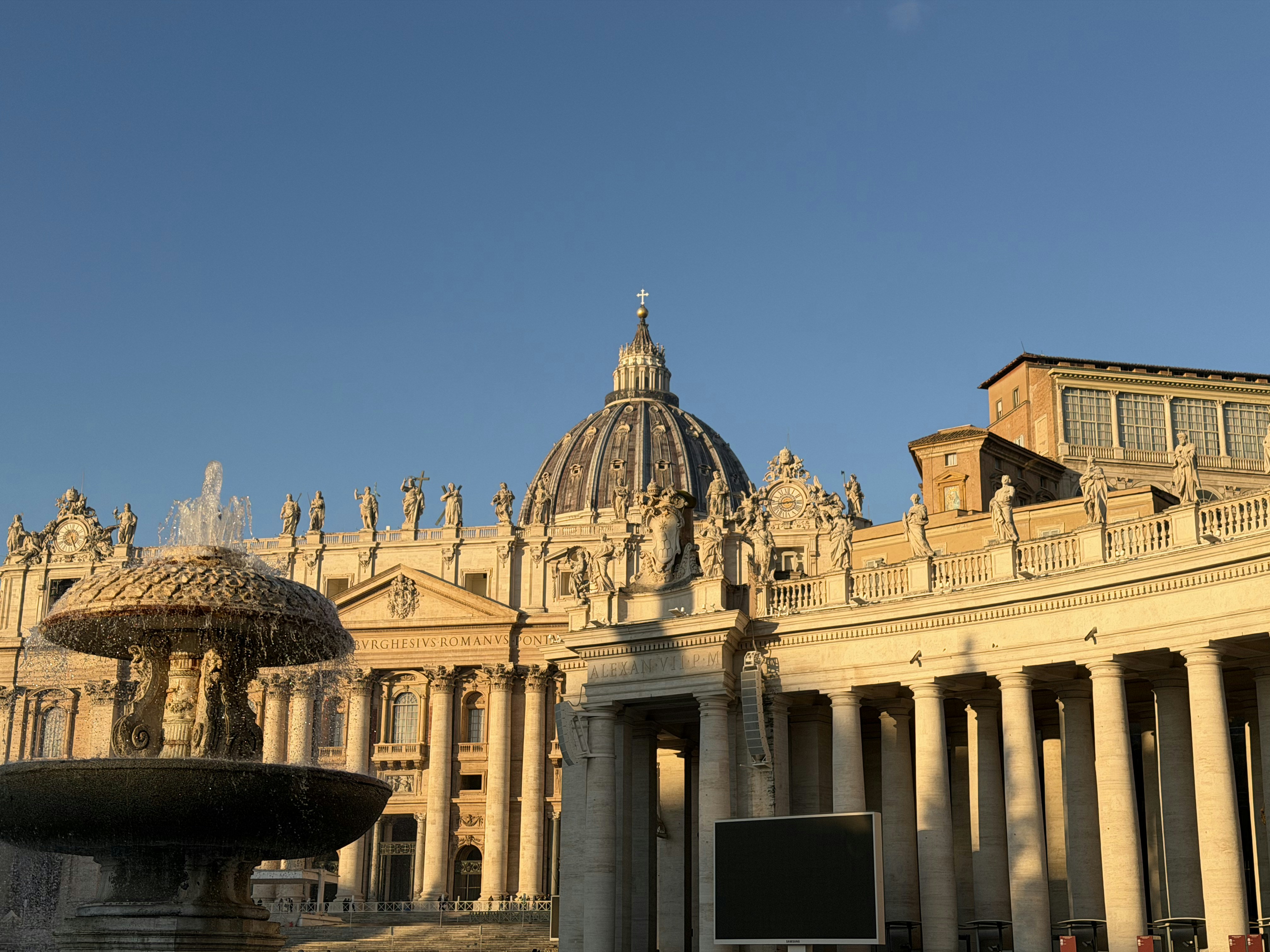 St. peter's basilica with a fountain in foreground.