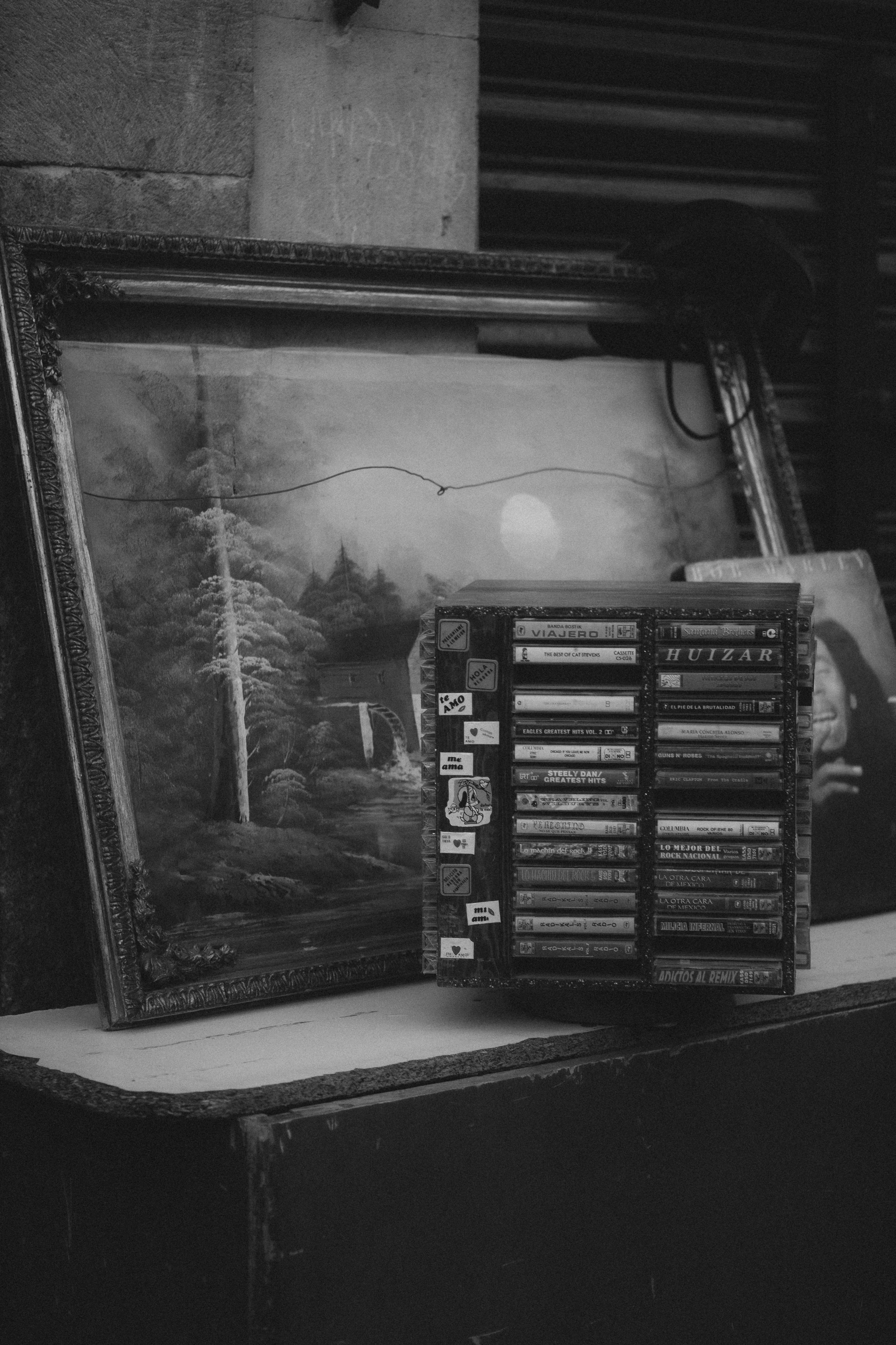 Framed painting and cassette tapes on a table