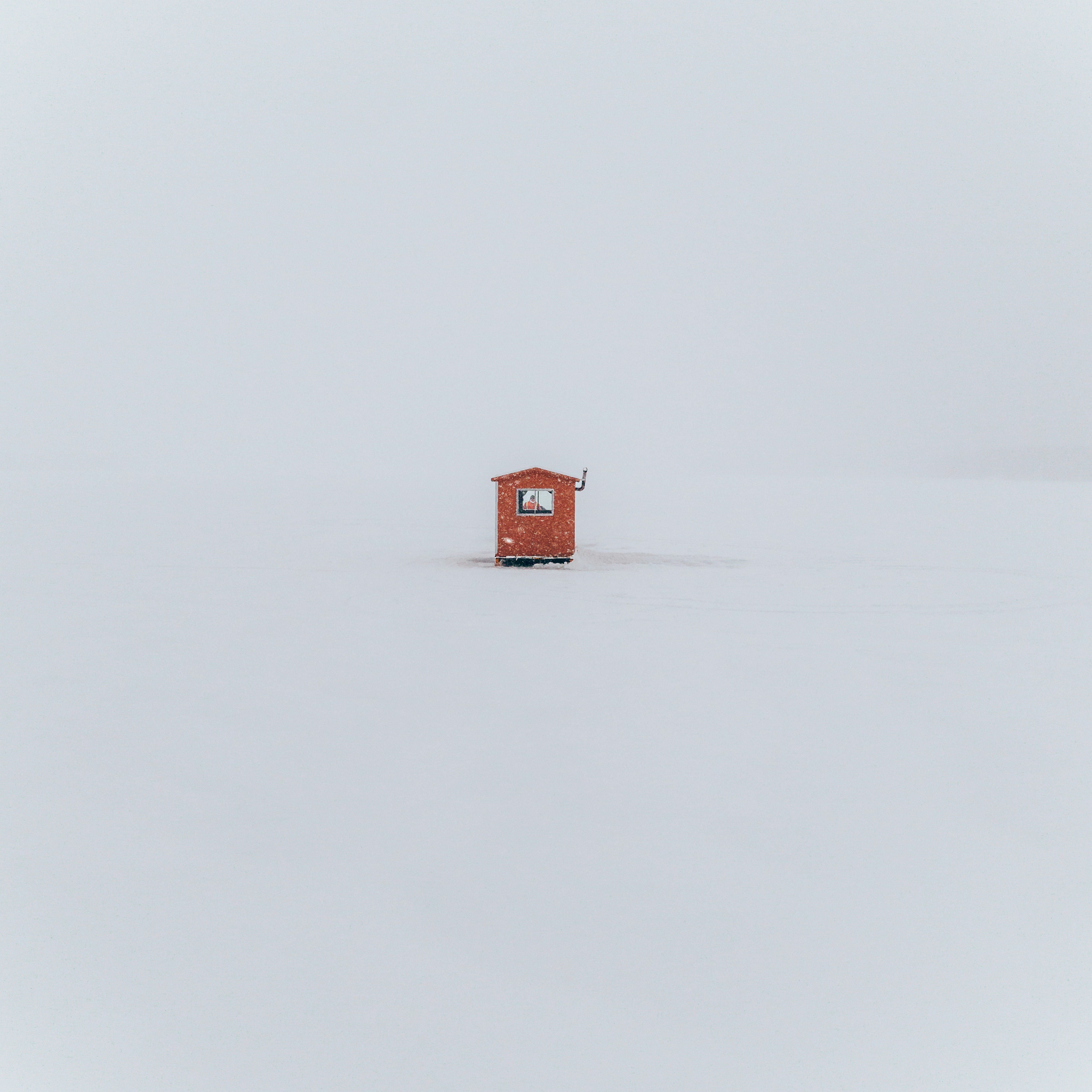 A small red cabin in a vast snowy landscape. photo – Free Peaceful ...