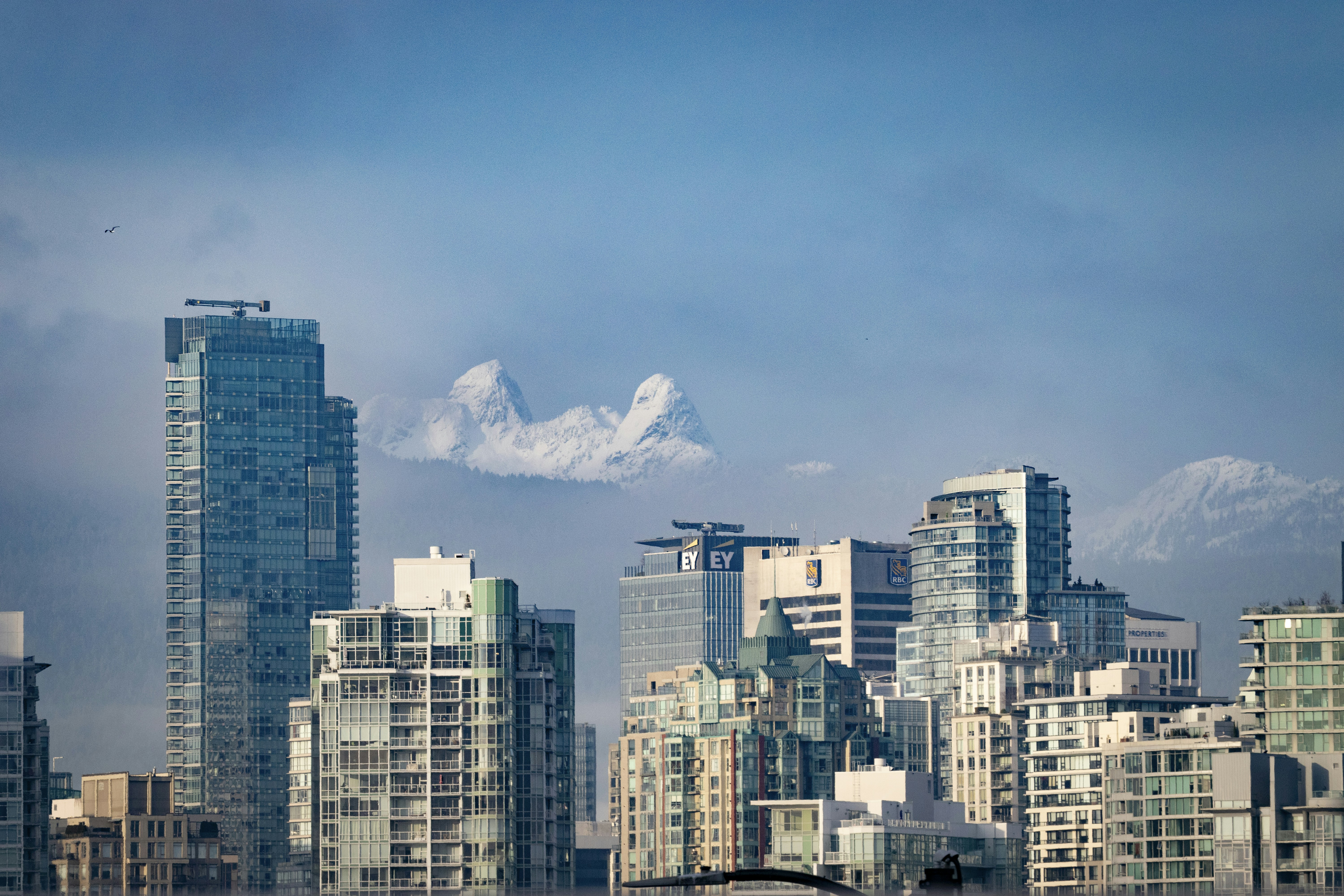 Modern skyscrapers against a cloudy blue sky.