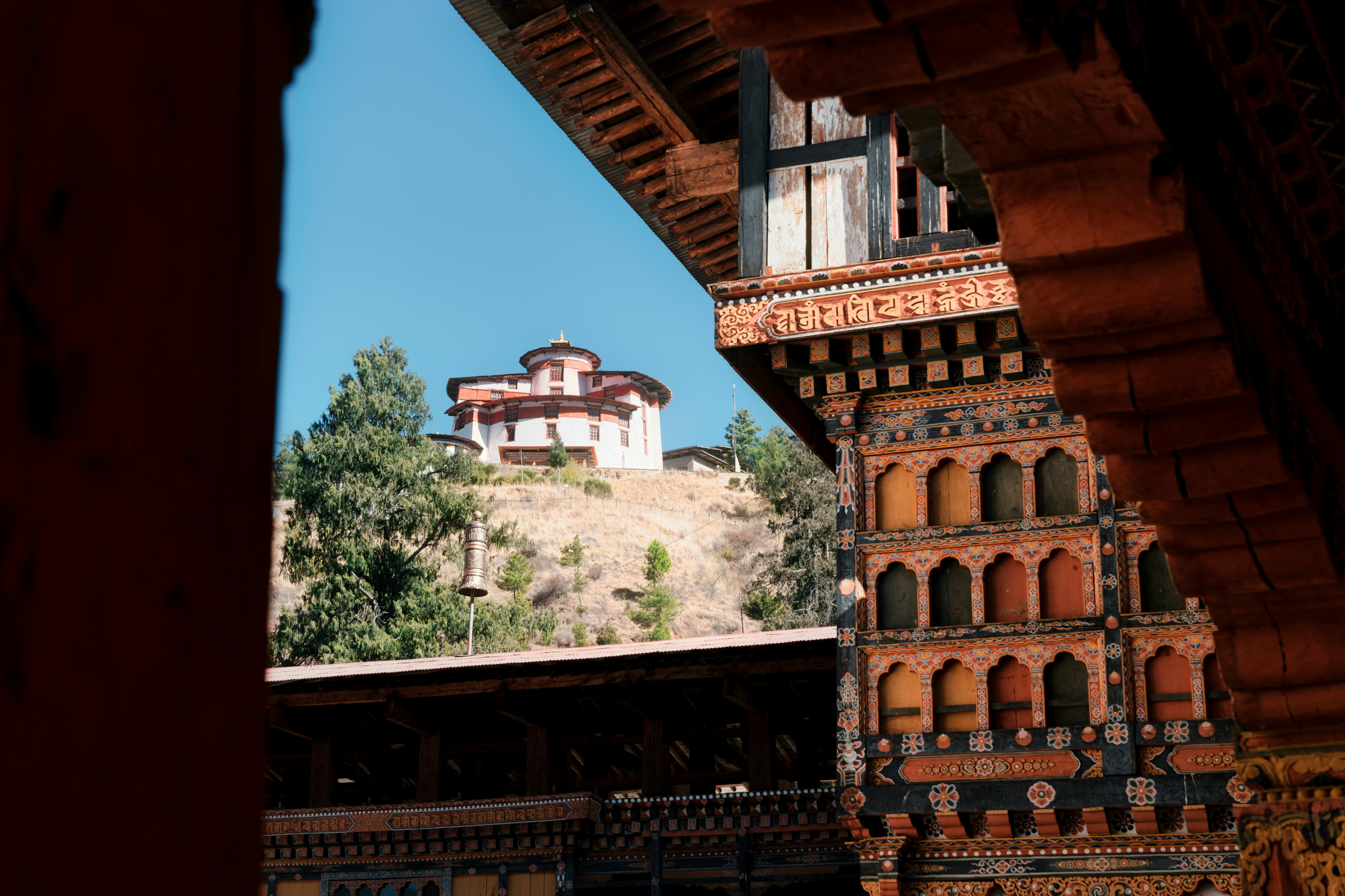 Traditional bhutanese architecture with a building on a hill.