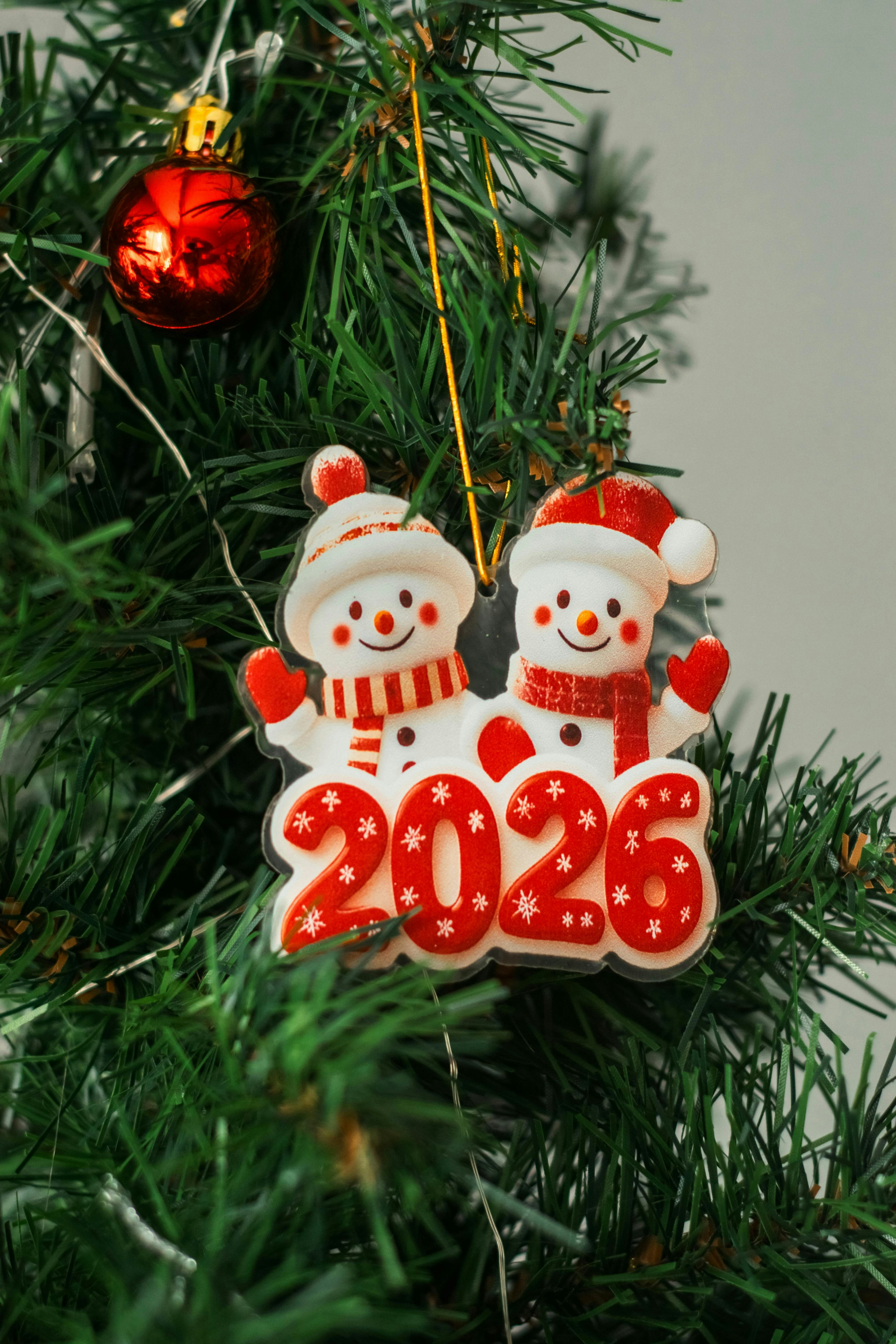 Two snowmen ornaments with the year 2026.