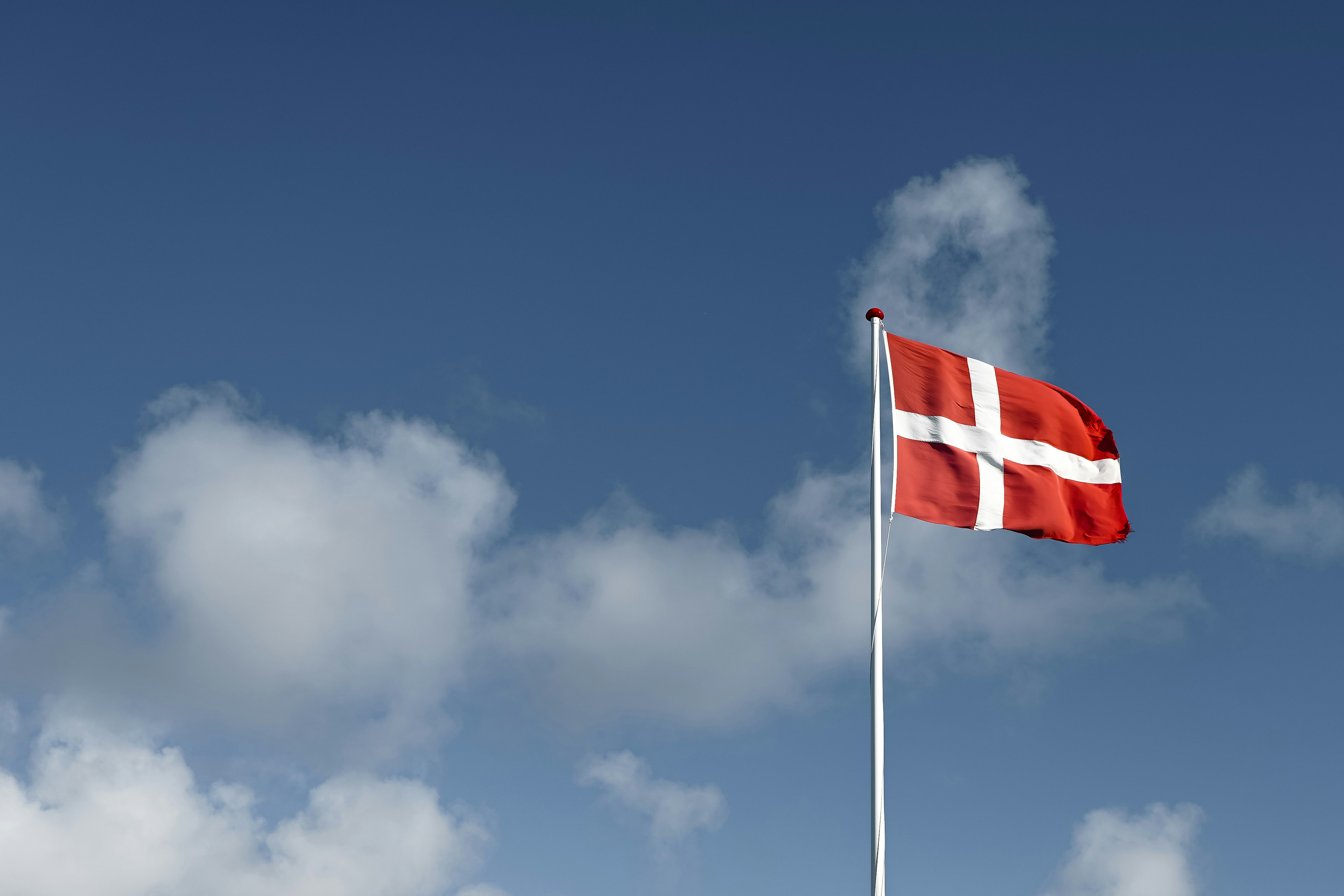 Danish flag waving against a blue sky