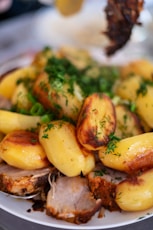 Roasted pork and potatoes with fresh dill garnish