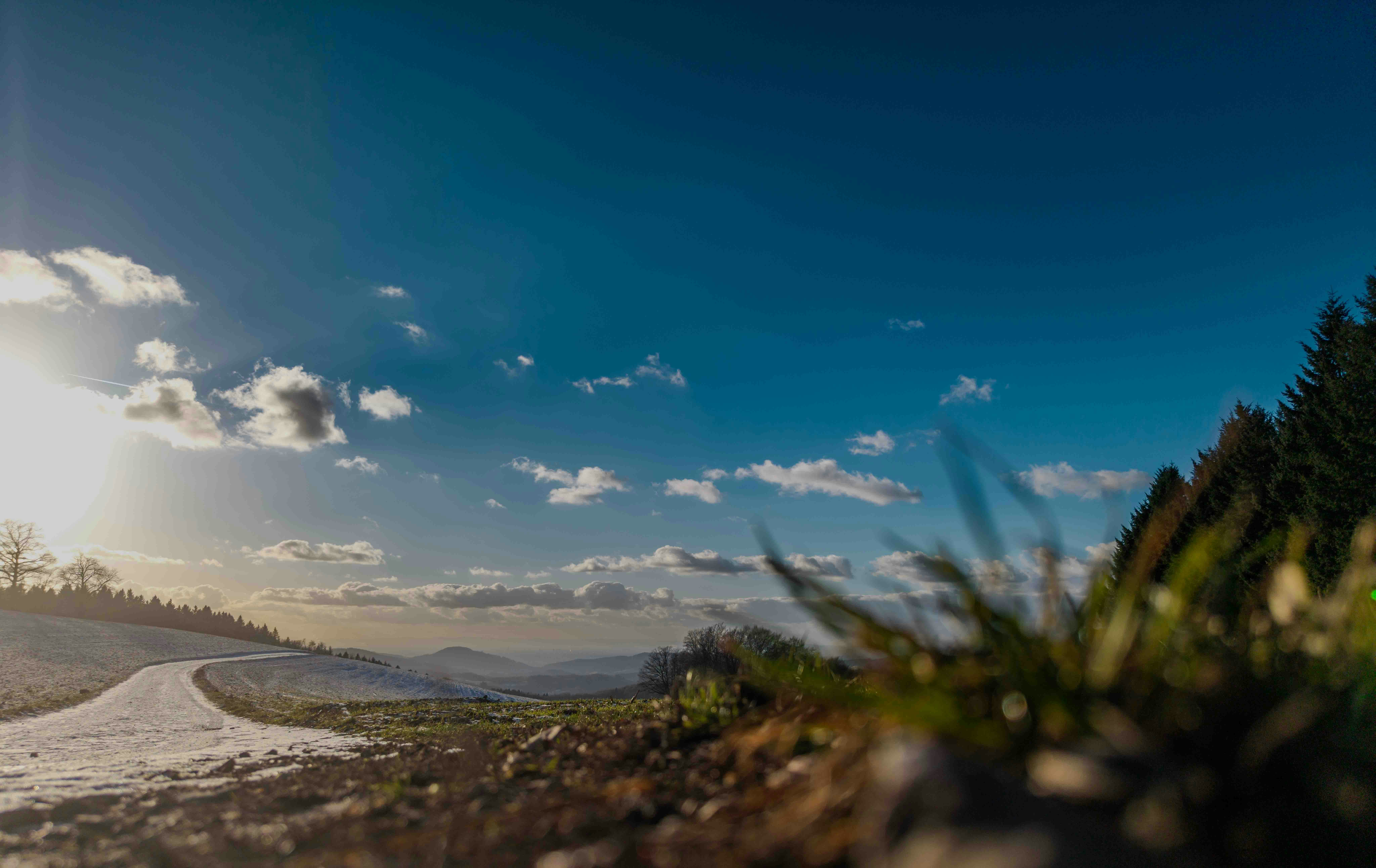 A winding road under a bright blue sky