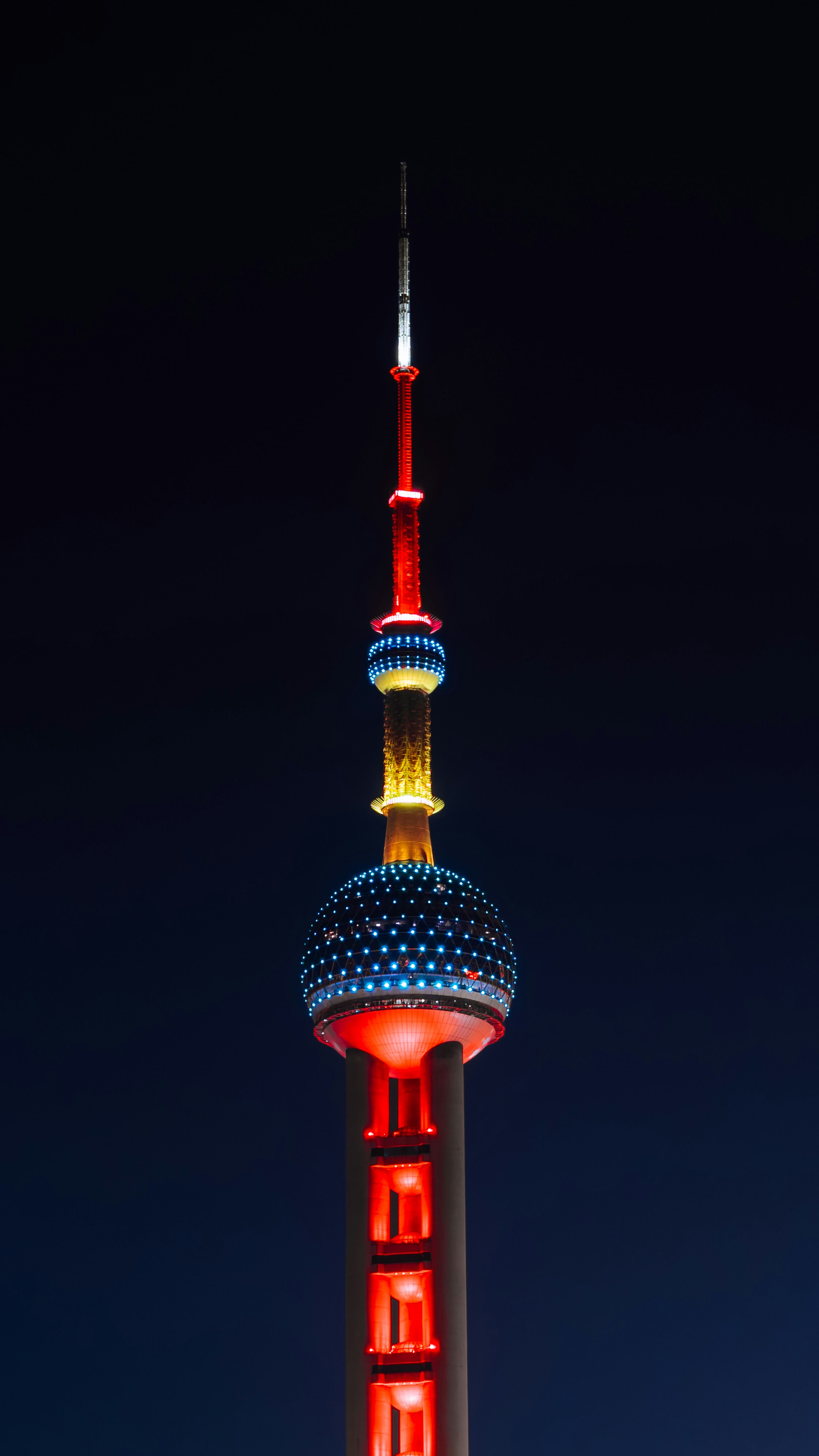 The oriental pearl tower illuminated at night against dark sky