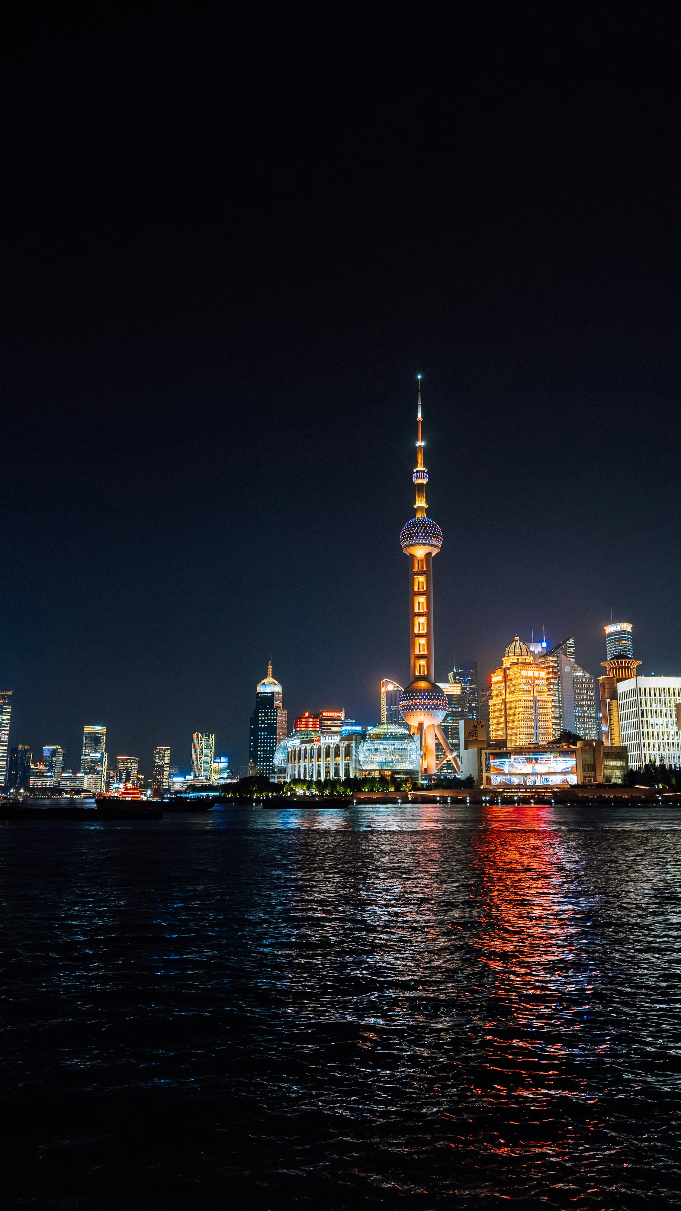City skyline with illuminated skyscrapers at night.