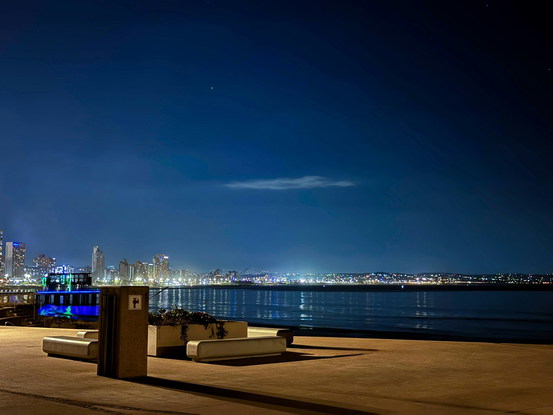 Durban city skyline illuminated at dusk across the water