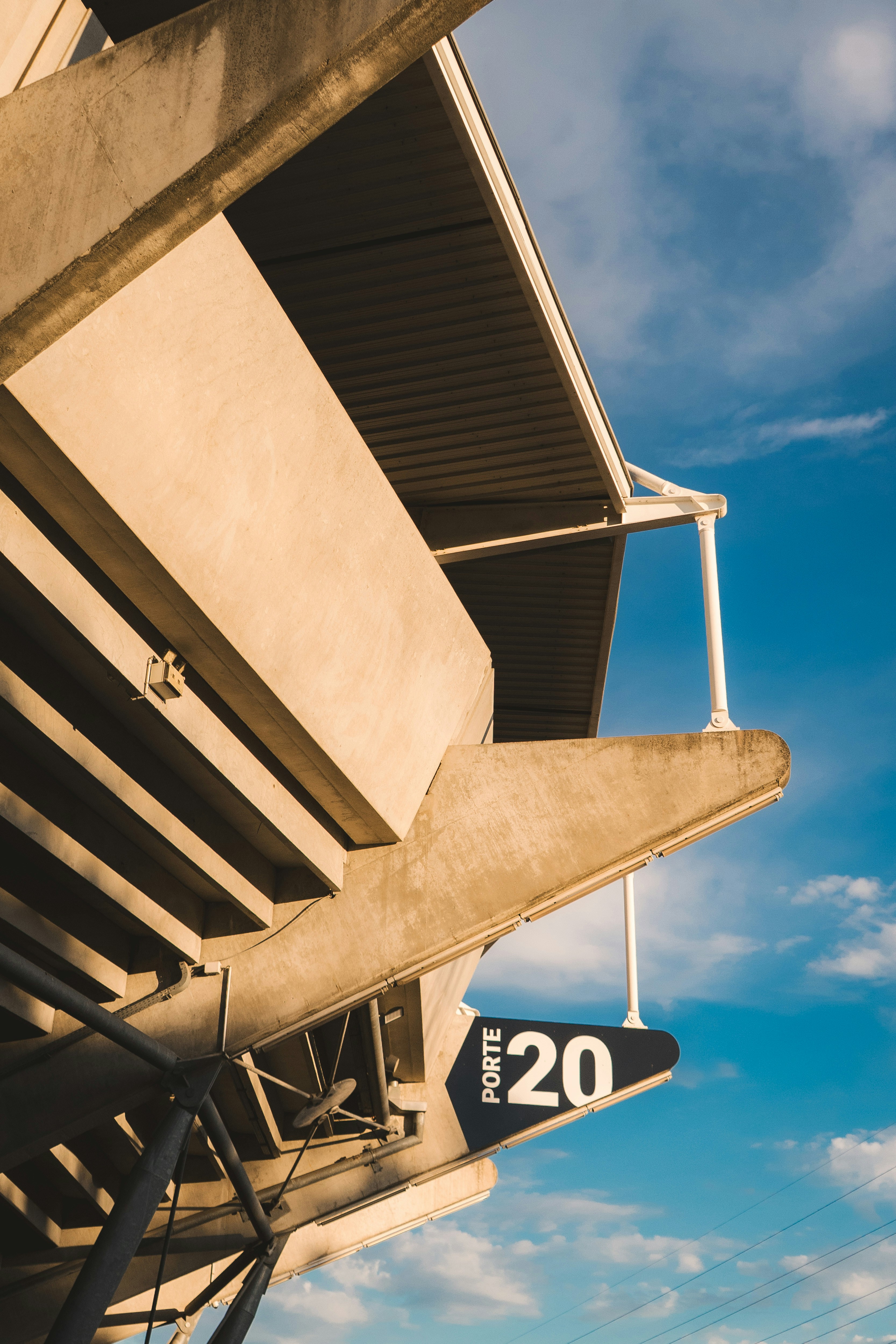 Concrete stadium seating with a clear blue sky.