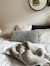 Bed with pillows and a knitted blanket