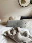 Bed with pillows and a knitted blanket