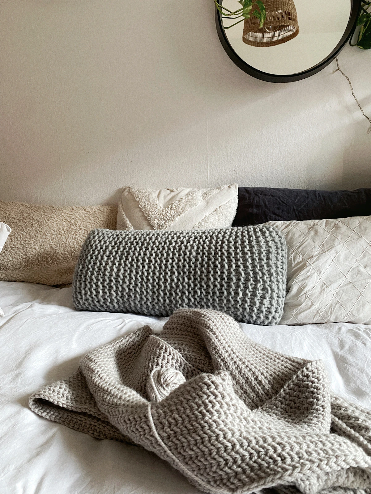 Knitted bed blanket with multiple sleeping pillows and textured pillow covers