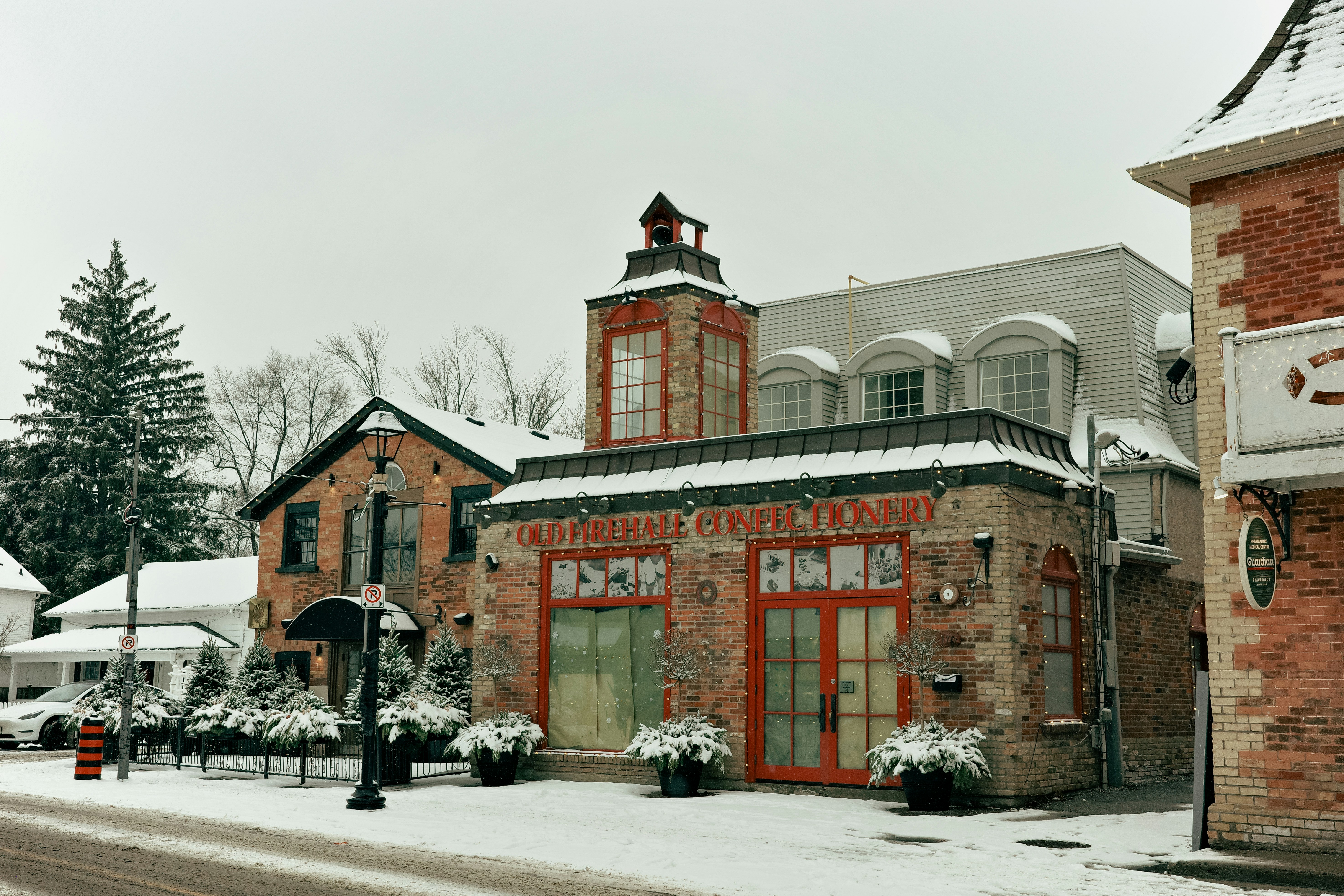 Brick building with red doors in winter snow