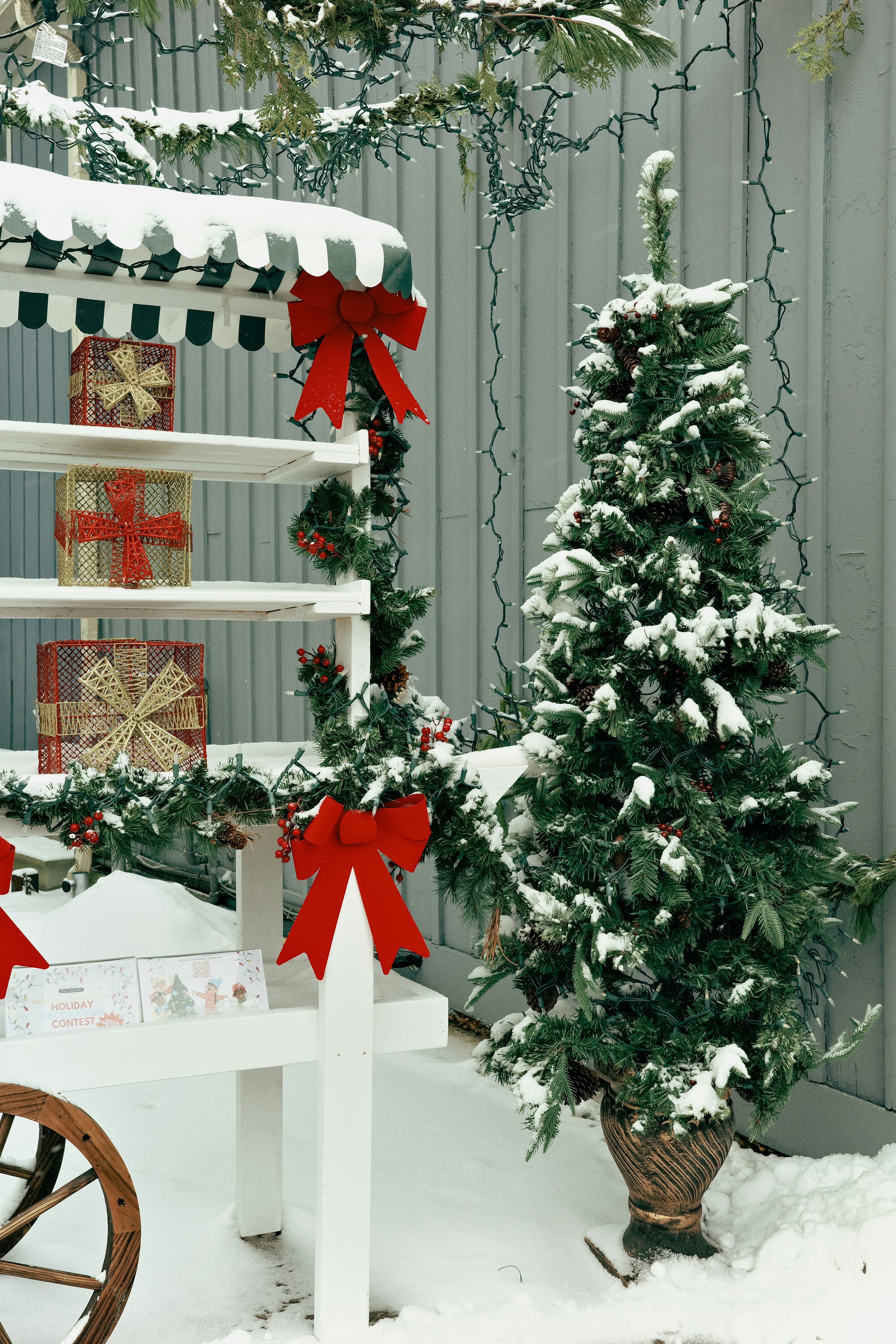 Christmas tree and decorated cart in snow