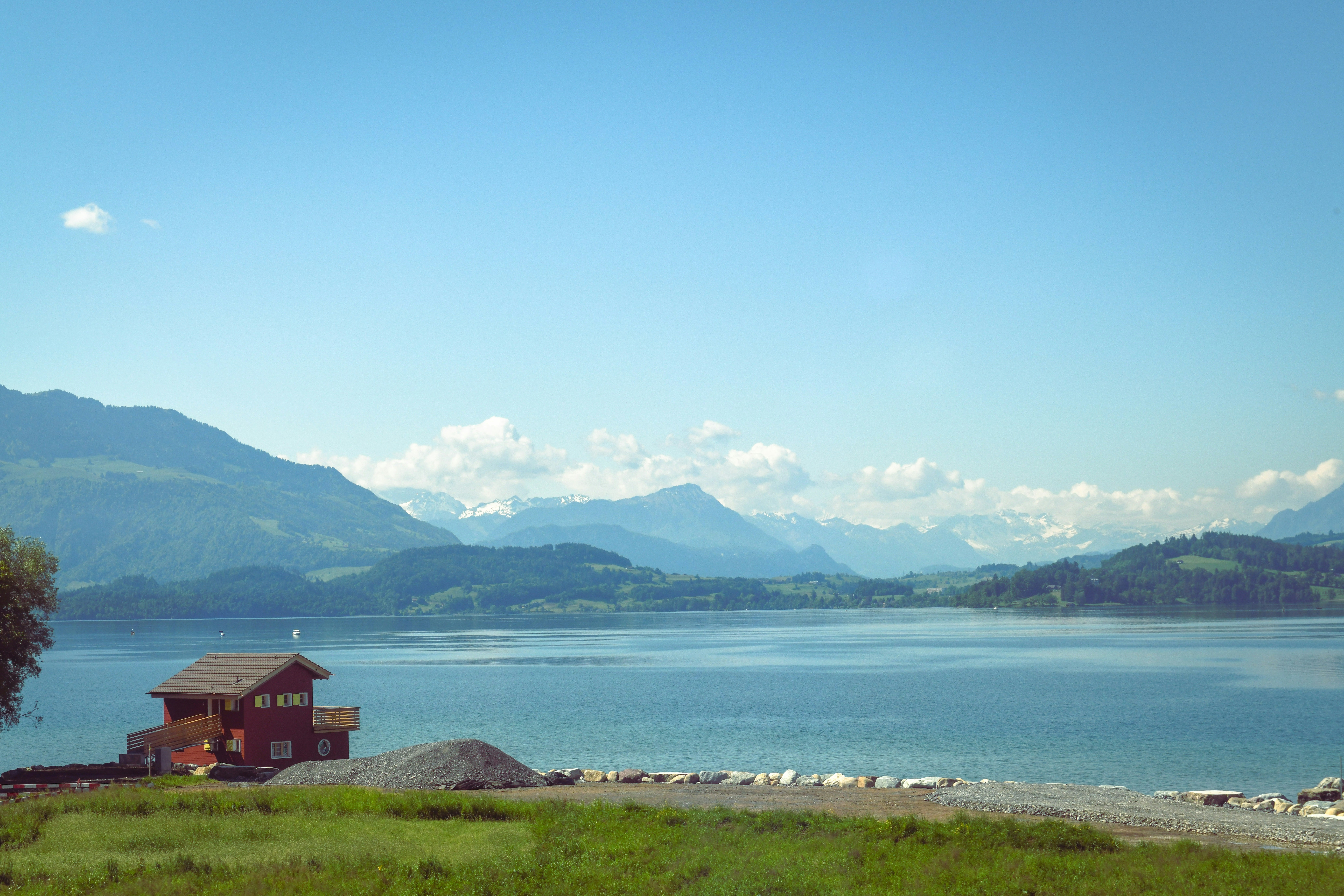 House on lake with mountains in background