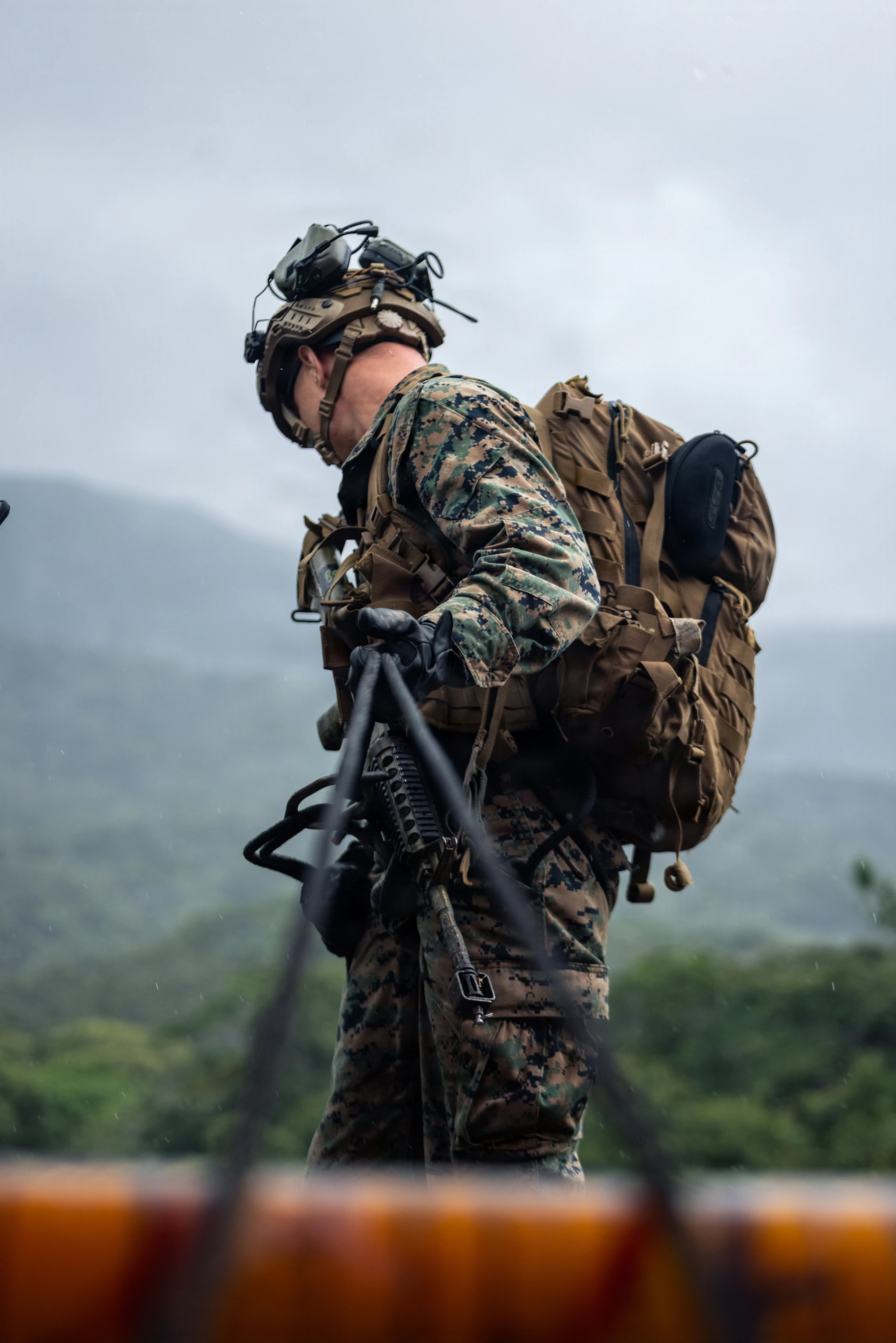 Soldier in camouflage gear carrying a large backpack