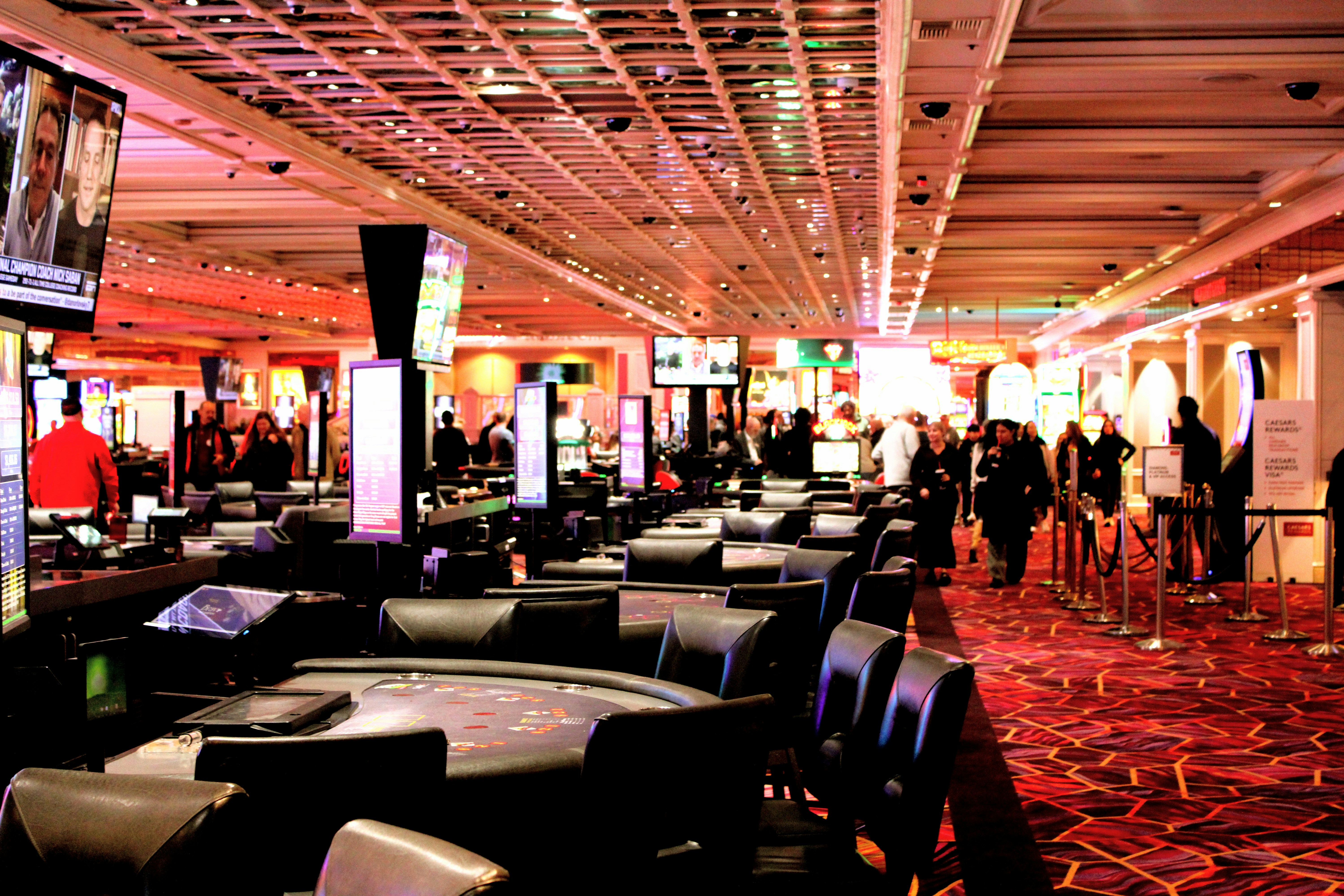 People walking through a busy casino gaming floor