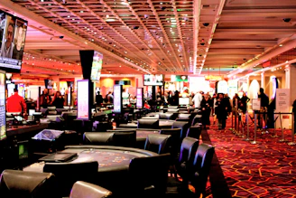People walking through a busy casino gaming floor