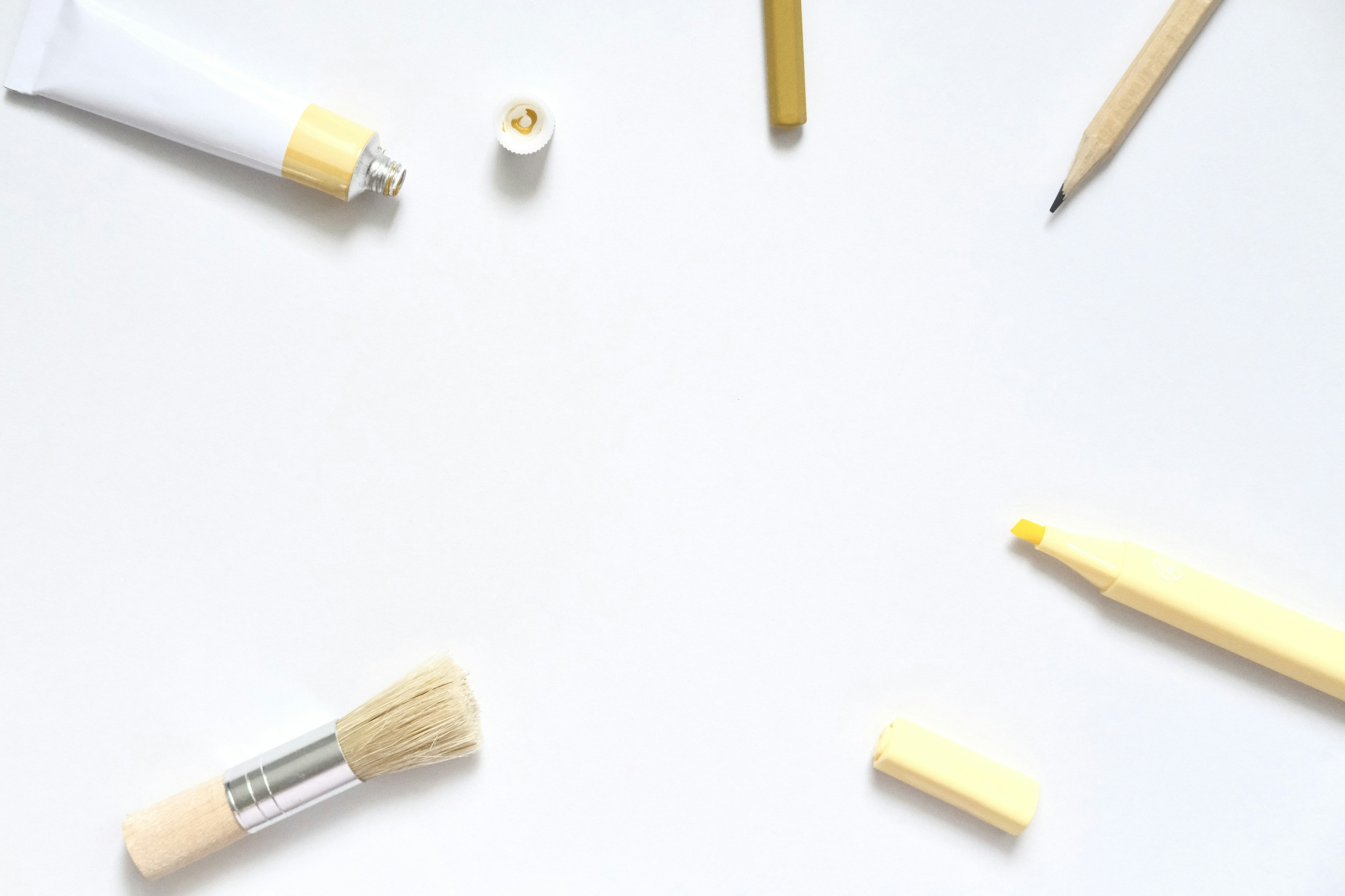 Art supplies arranged on a white surface