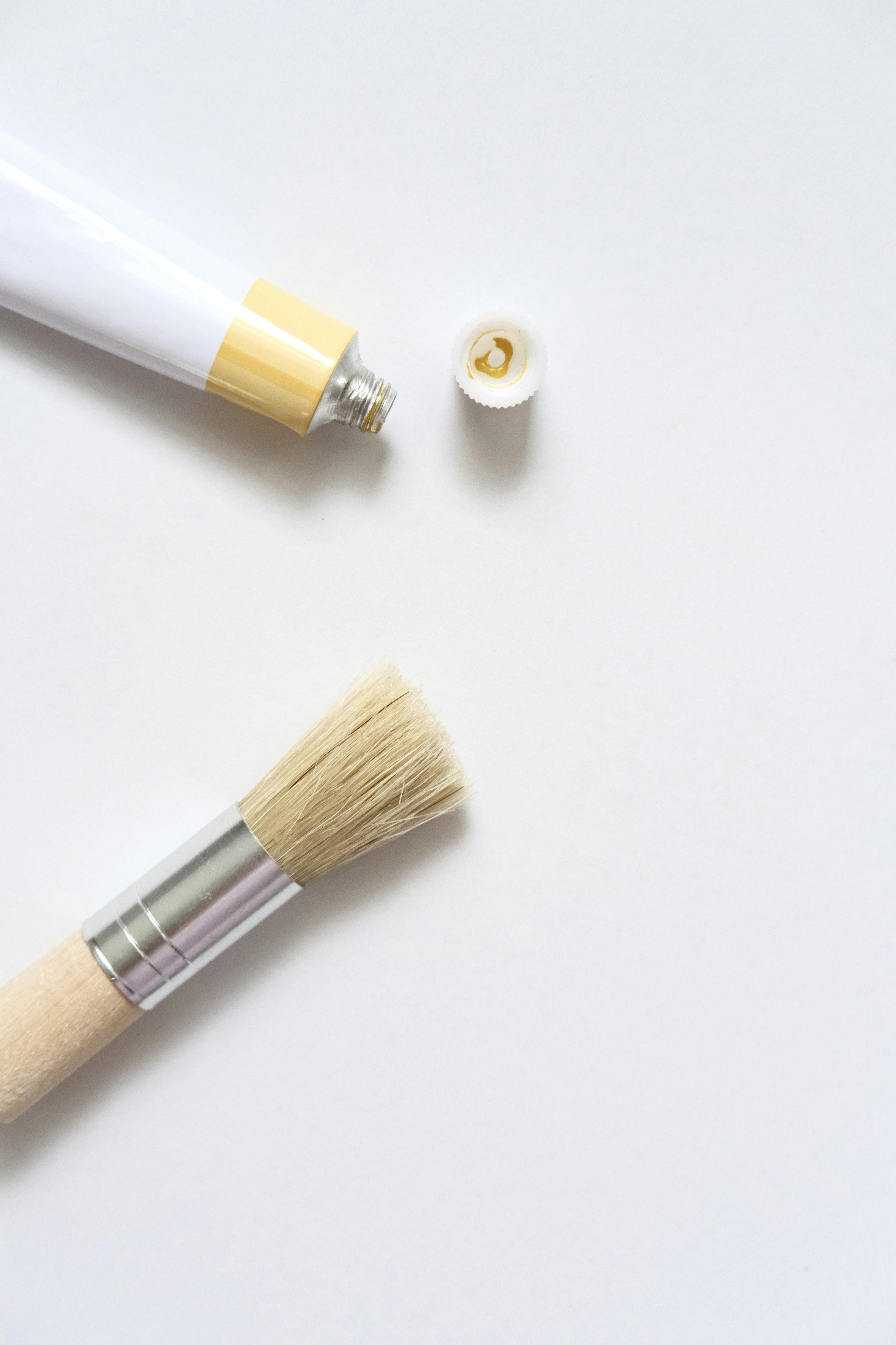 A tube of yellow paint and a brush.