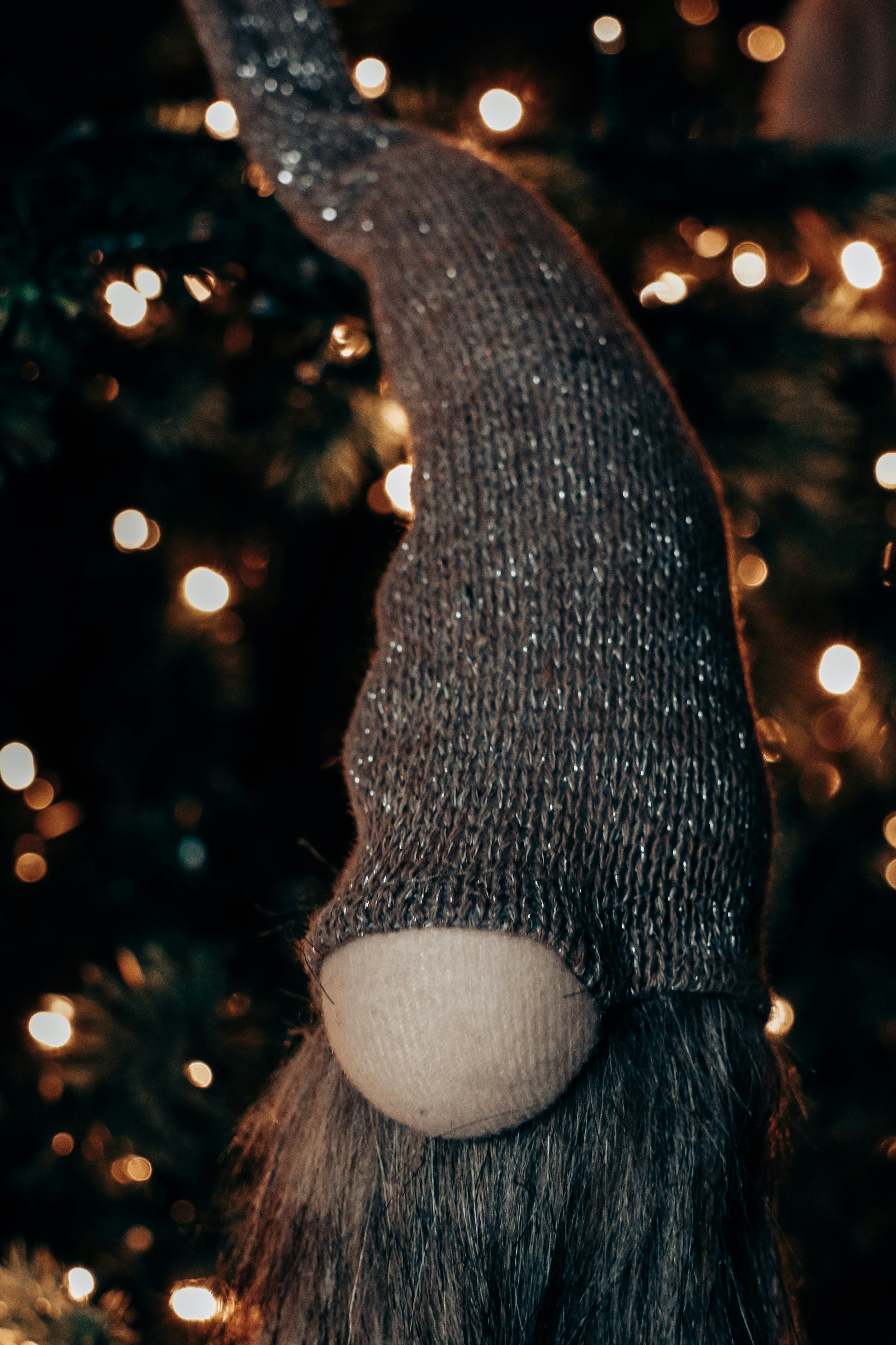 A festive gnome decoration with bokeh lights