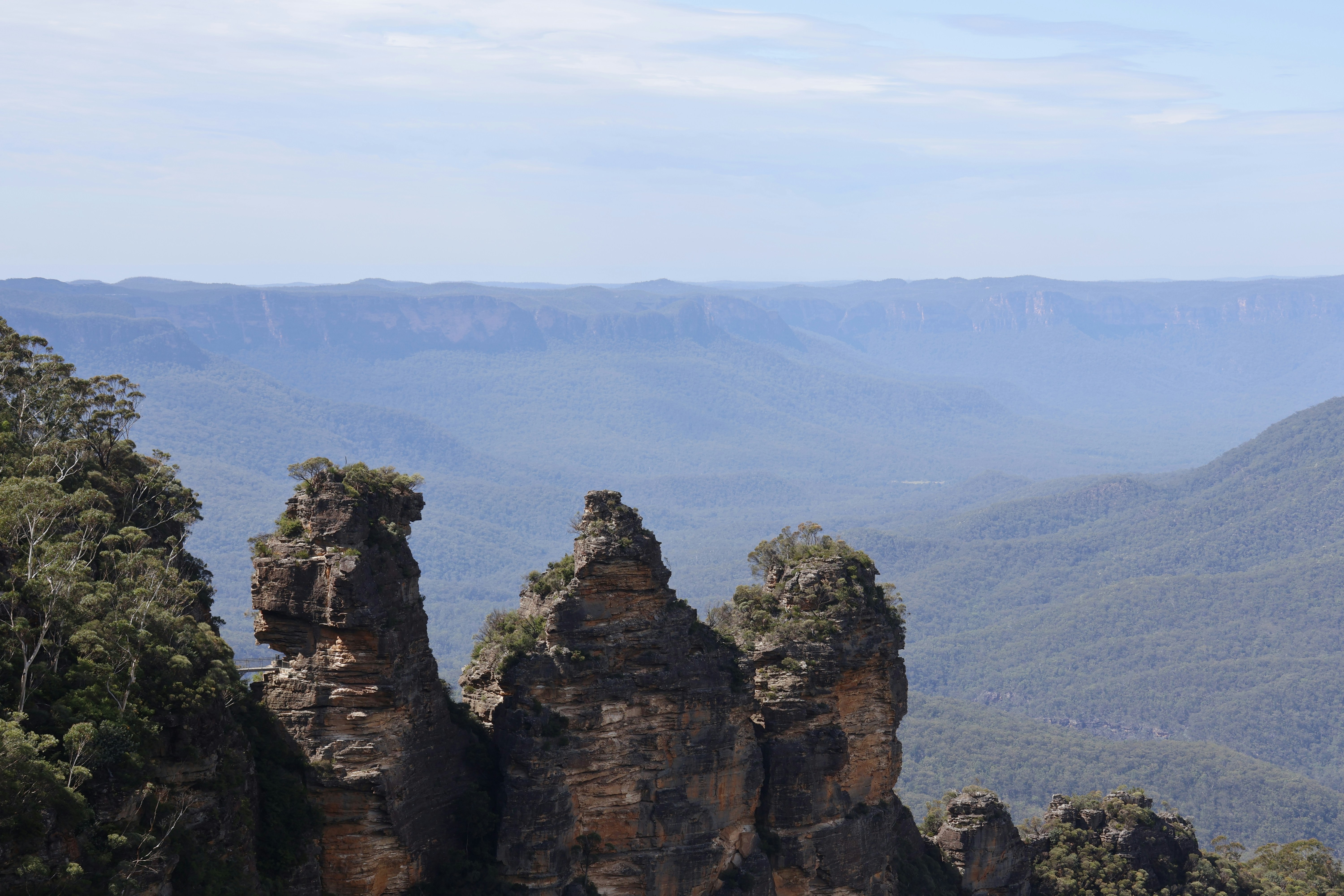 Three rock formations in a mountainous landscape